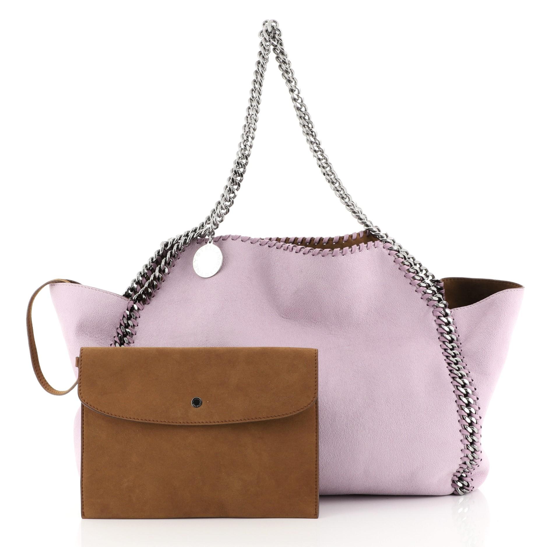 This Stella McCartney Falabella Reversible Tote Shaggy Deer Small, crafted in purple shaggy deer, features chain link strap and trim, whipstitched edges, and gunmetal-tone hardware. It opens to a brown suede interior. 

Estimated Retail Price: