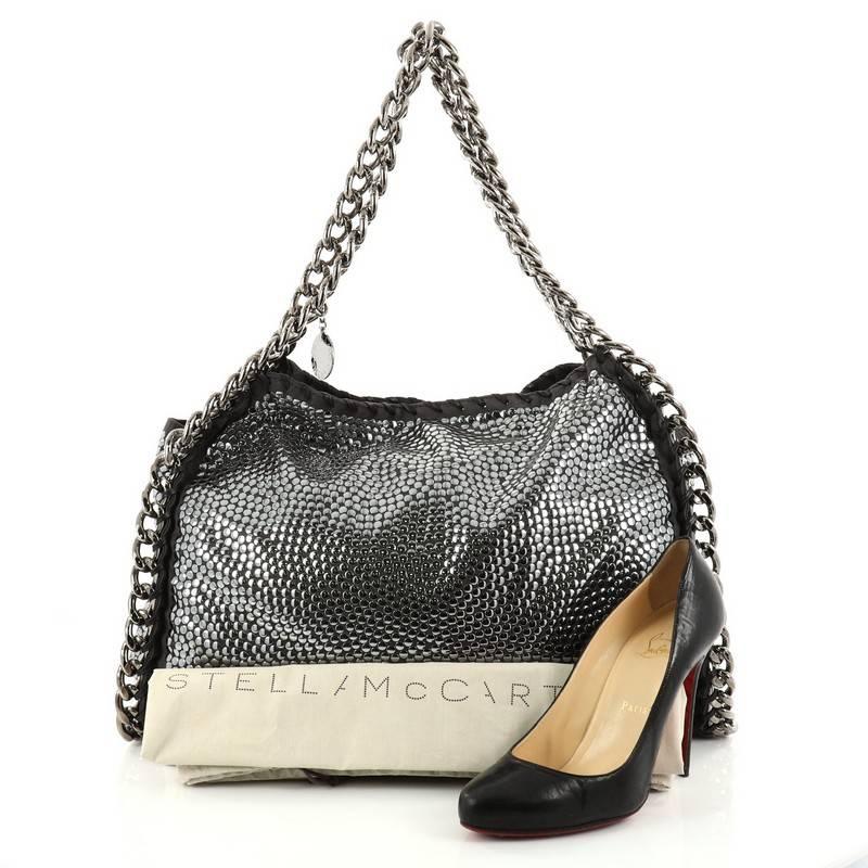 This authentic Stella McCartney Falabella Tote Studded Faux Suede Large is perfect for casual day-to-day excursions. Crafted from gray faux suede with smooth chrome-tone studs, this no-fuss, lightweight eco tote features silver-tone chain link strap