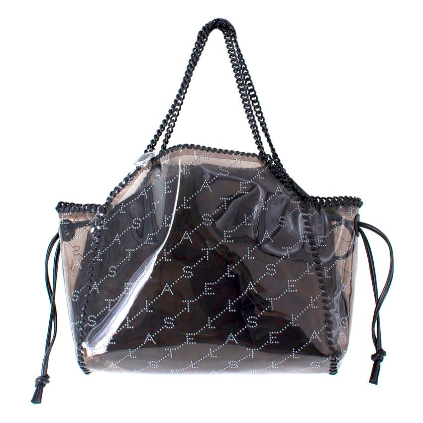 Stella McCartney Falabella Transparent PVC Tote Bag

- Black Falabella Transparent PVC Tote bag
- Monogram decorative perforations and stitched trimming
- Comes with a detachable faux leather pouch with a drawstring fastening
- Signature chain and