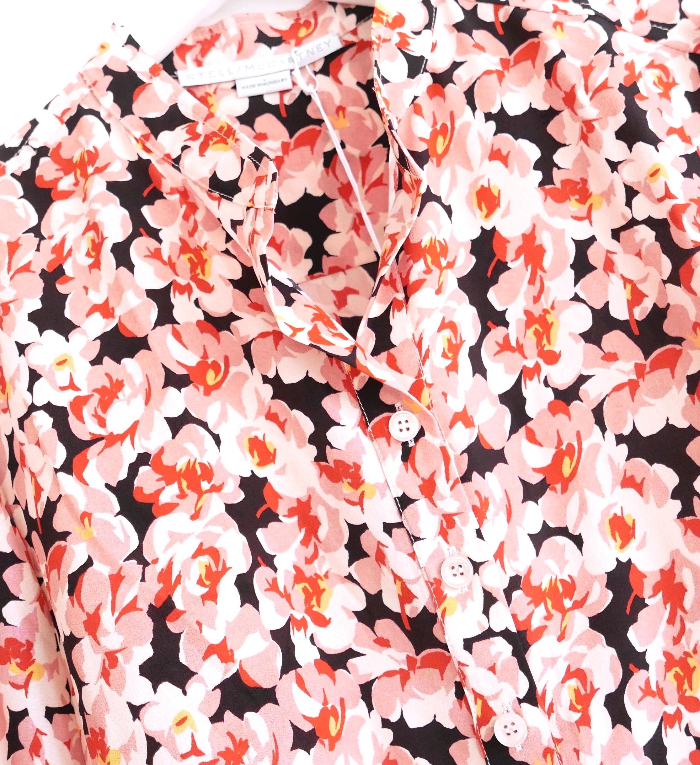 Gorgeous Stella McCartney floral print silk shirt. Bought for £595 and new with tags/spare button. Made from pink and coral blossom print silk crepe de chine, it has a very relaxed fit with open neck, button front and curved hem. Size IT34/UK2 and
