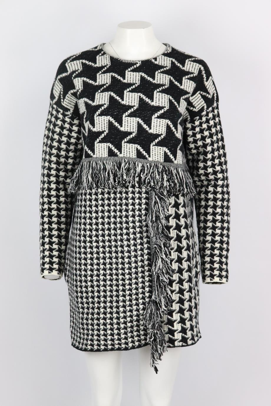 Stella McCartney fringed houndstooth wool mini dress. Black and white. Long sleeve, crewneck. Pull on. 100% Wool. Size: IT 40 (UK 8, US 4, FR 36) Bust: 45 in. Waist: 43 in. Hips: 43 in. Length: 32 in. Very good condition - Light signs of wear; see