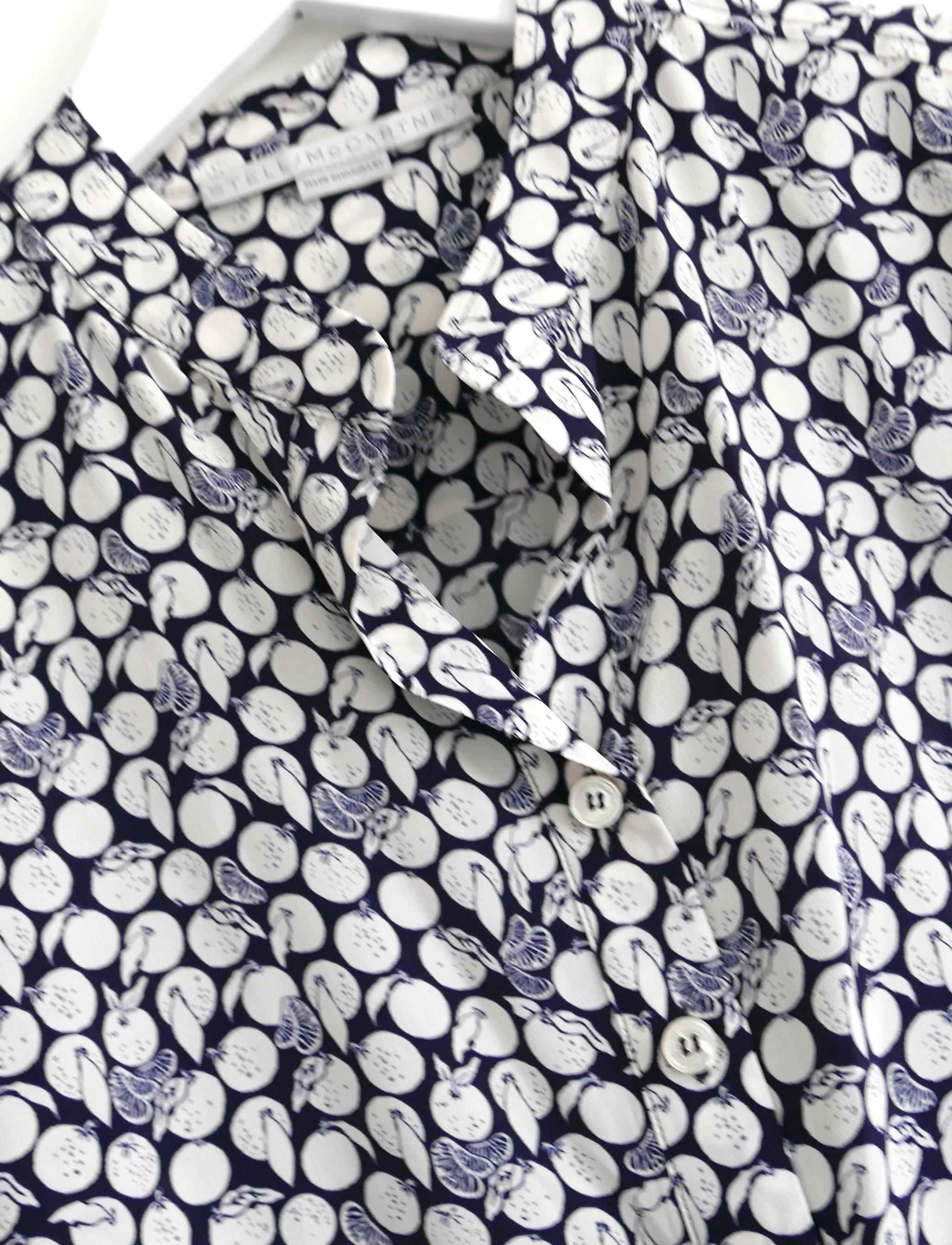 Yummy Stella McCartney fruit print silk shirt. Bought for £595 and unworn. Made from navy and white orange print silk crepe de chine, it has a very relaxed fit with open neck, half button front and curved hem. Size IT34/UK2 and will fit several