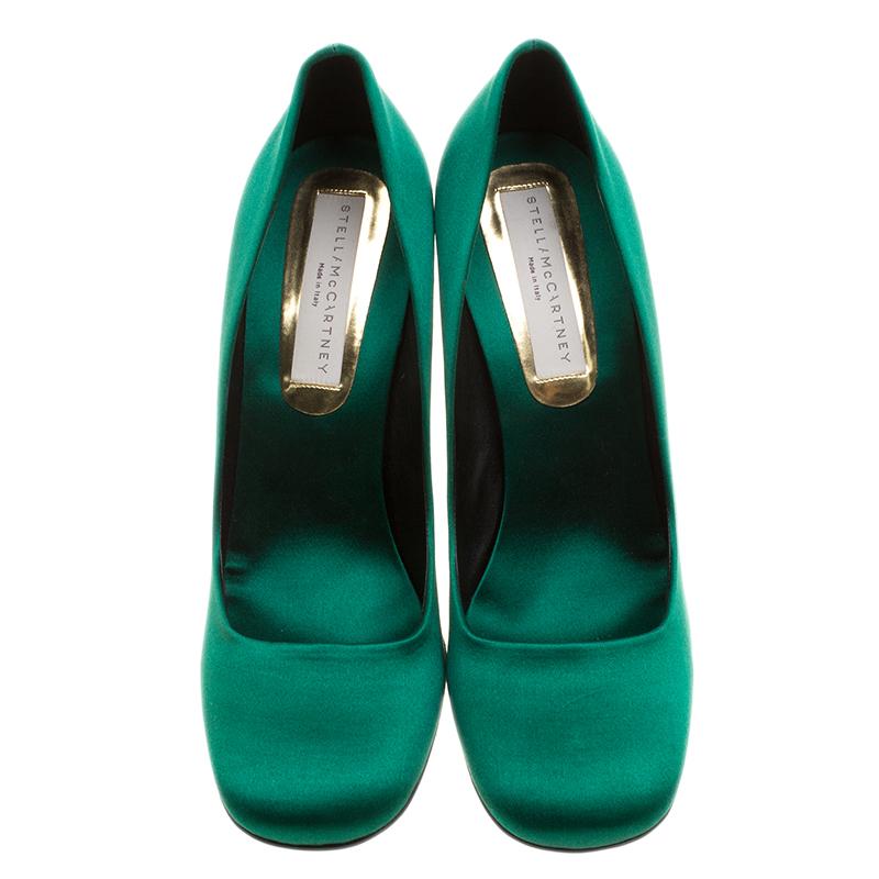 Revamp your footwear collection by adding this pair of dazzling green Stella McCartney pumps to the list. These pumps, having a satin exterior, is ideal to be worn on all occasions. They feature cabochon stone embellished block heels and leather