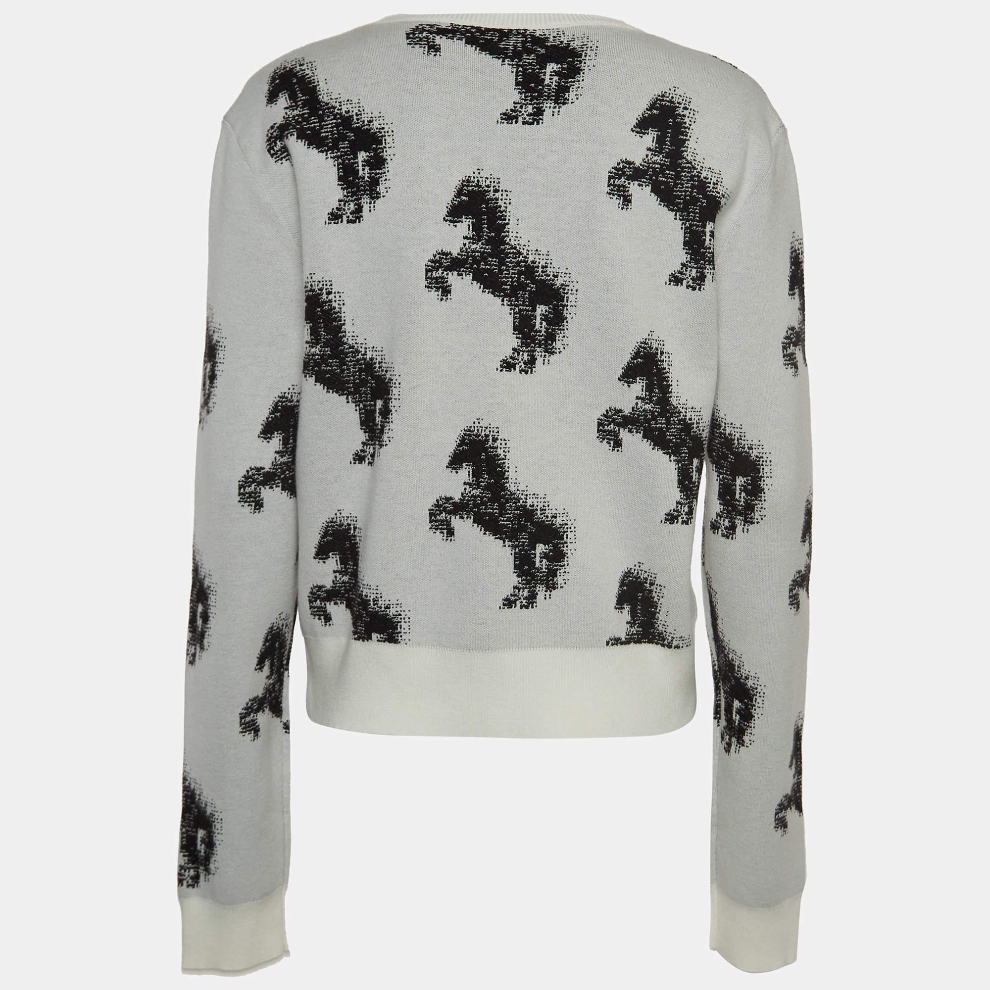 The Stella McCartney sweatshirt is a stylish blend of comfort and sophistication. Featuring a pixelated horse design in monochromatic hues, the knit sweatshirt offers a cozy, fashionable statement for casual elegance.

