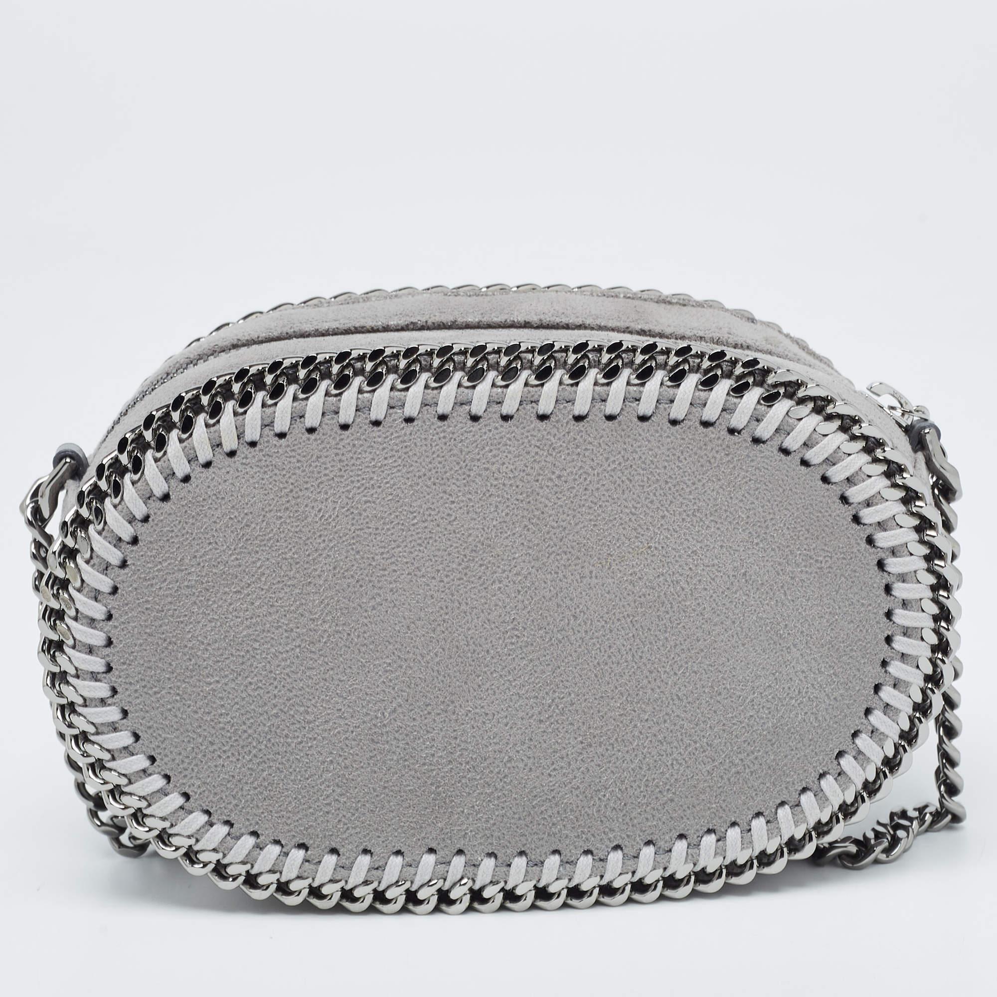 The Stella McCartney Falabella Crossbody Bag epitomizes sustainable luxury. Crafted with cruelty-free materials, its sleek oval silhouette and signature chain trim exude sophistication. The muted grey hue complements any outfit, while the crossbody