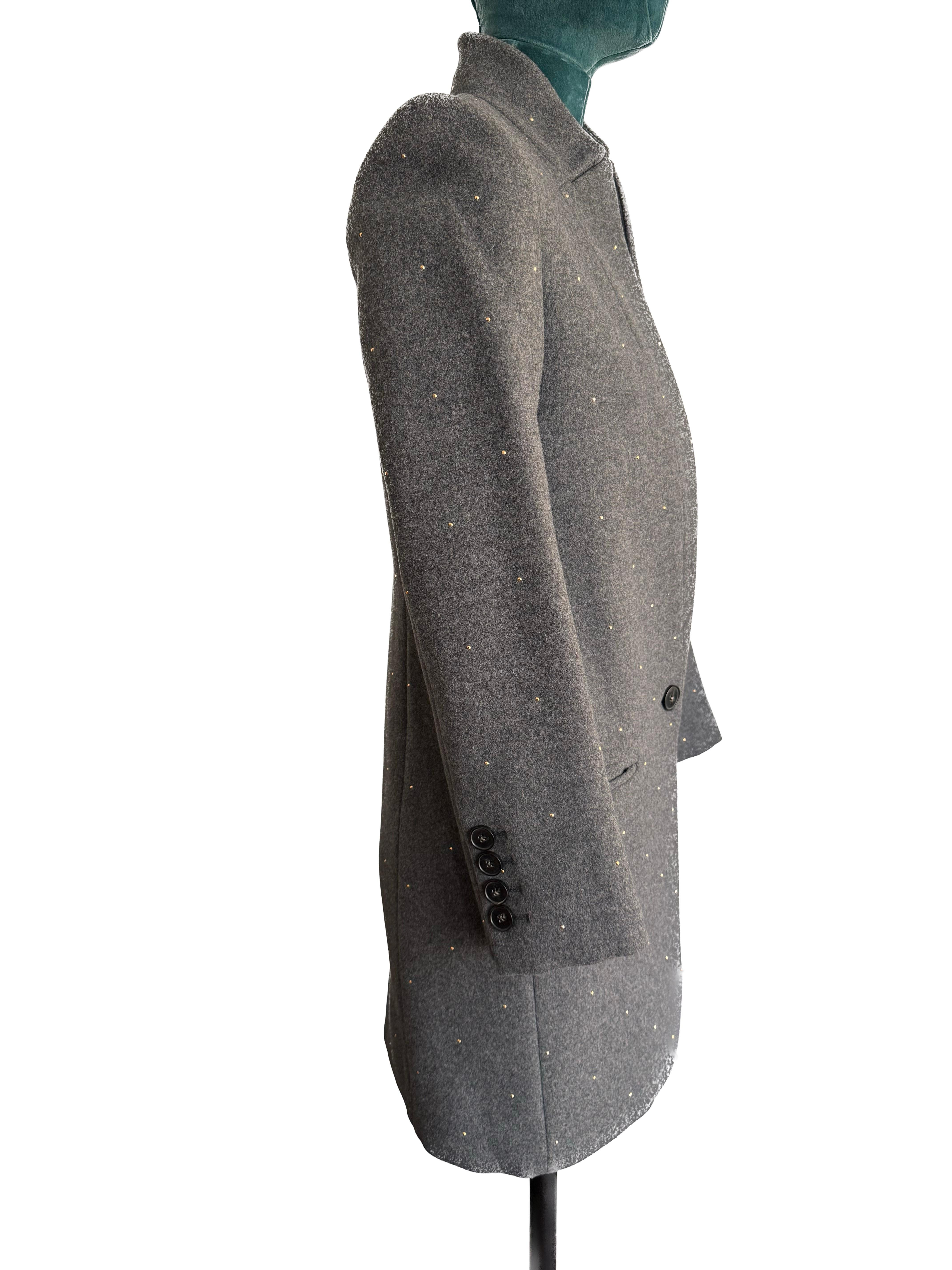 Introducing the Stella McCartney Grey Wool Blend Cashmere Mid-Length Blazer Jacket – a sartorial masterpiece that seamlessly blends modern luxury with classic British equestrian influences. This exquisite piece, in excellent condition, is a