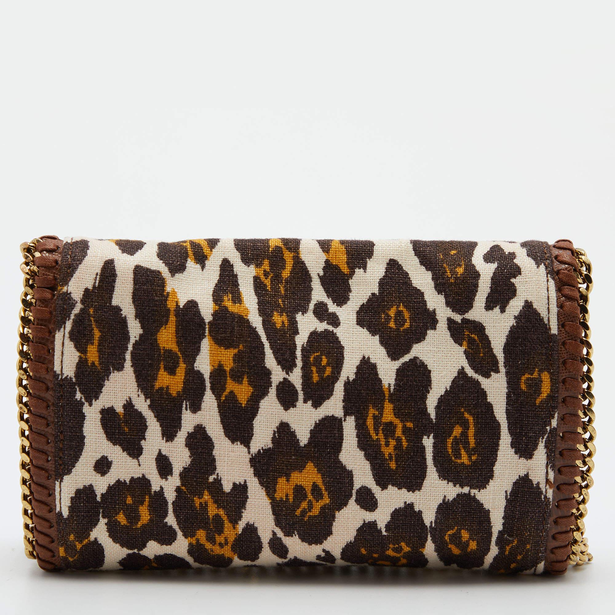 This Falabella crossbody bag from Stella McCartney is one of her most popular designs. It is crafted in leopard-print canvas & faux leather with the addition of gold-tone hardware forming the chain-trimmed edges and long chain strap. It has a