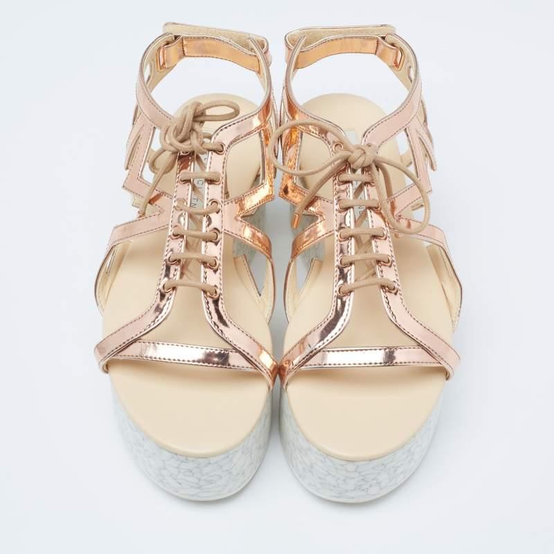 With lace-up vamps and platforms, these Stella McCartney women's sandals are highly fashionable. Created from faux patent leather in a metallic bronze hue, the pair features rubber soles, open toes, and velcro closure.

Includes: Original Dustbag,