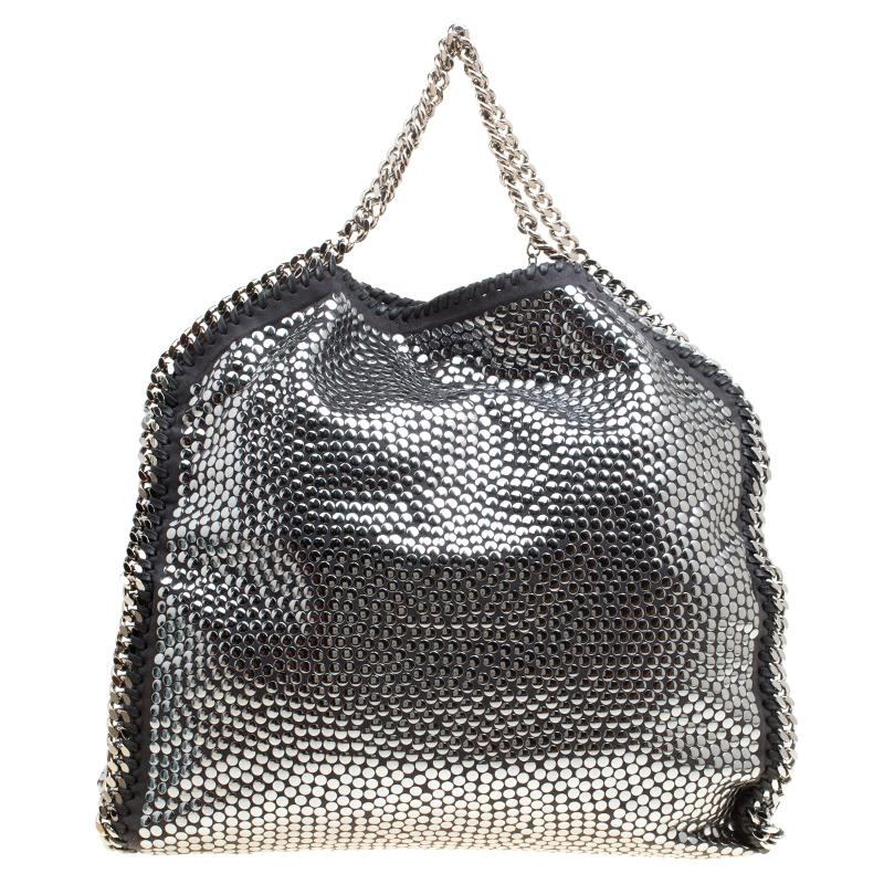 Stella McCartney is known for her chic designs and this Falabella tote perfectly embodies this trait. Crafted in Italy from metallic faux leather with a fabric interior, this tote has a beautiful studded exterior and black-tone chain details at its