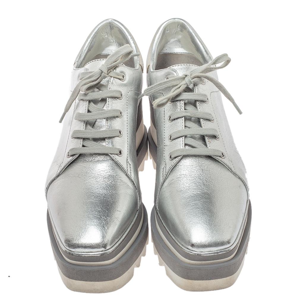 Stella McCartney exudes her high style and unique fashion taste with these Elyse sneakers. They are brimming with exquisite details like the metallic silver faux leather exterior, the laces, the thick platforms, and the logo on the counters. Grab