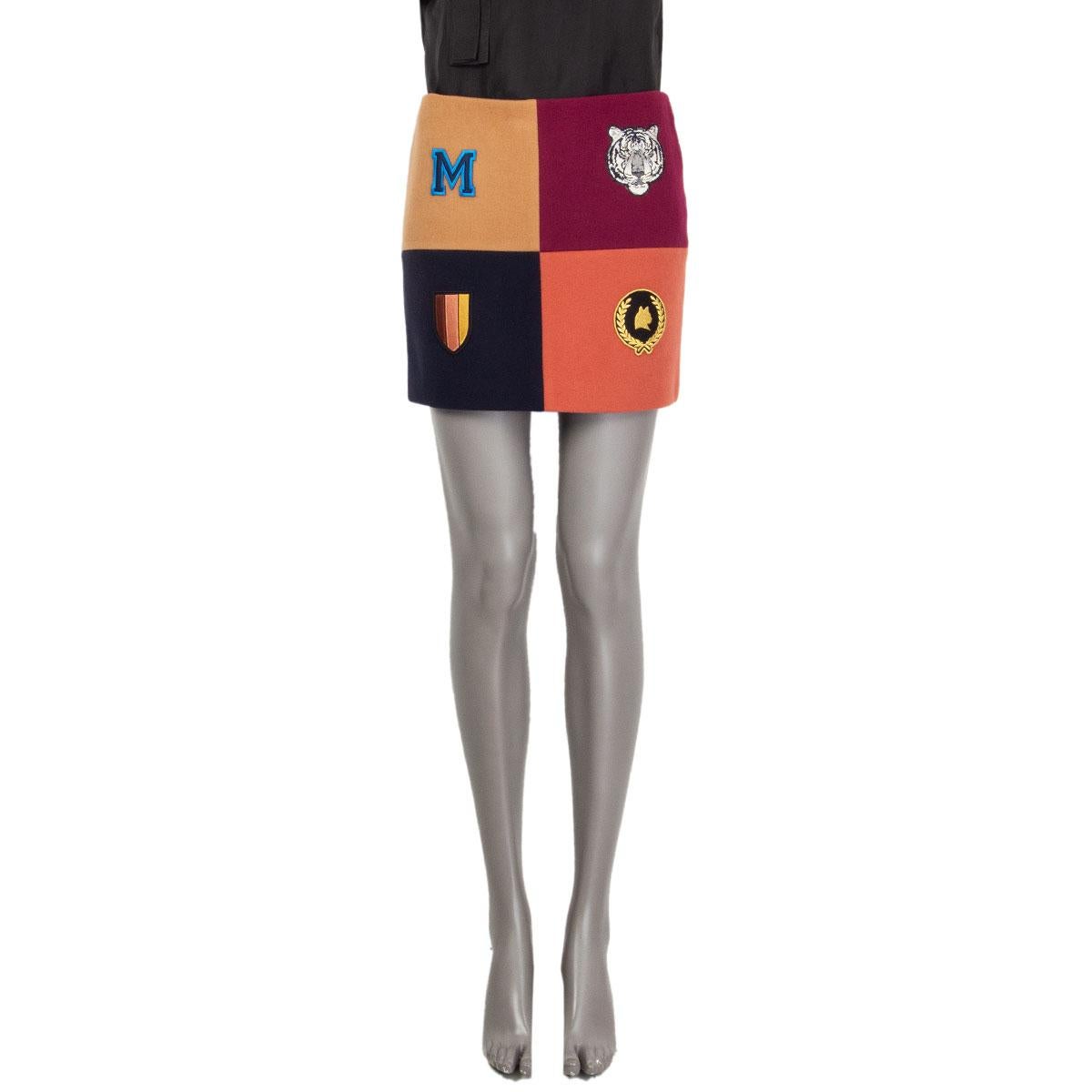 authentic Stella McCartney 'Moana' mini skirt in midnight blue, mauve, beige and magenta wool (75%), polyamide (25%) and lined in black viscose (52%) and cotton (48%). Has four stitched on patches on the front. Opens with a zipper on the back. Has