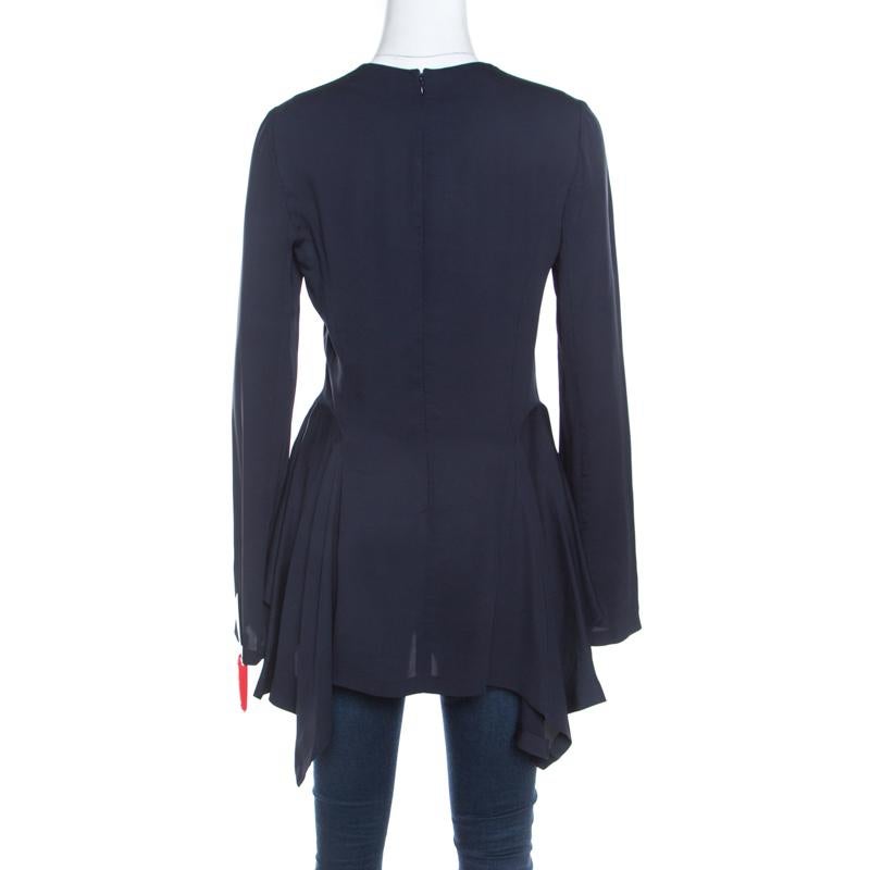 Add a twist to your wardrobe by adding this top from Stella McCartney. This magnificent navy blue top with its trendy design is sewn from 100% viscose. The top flaunts a peplum detail and long sleeves.

Includes: Price Tag, The Luxury Closet