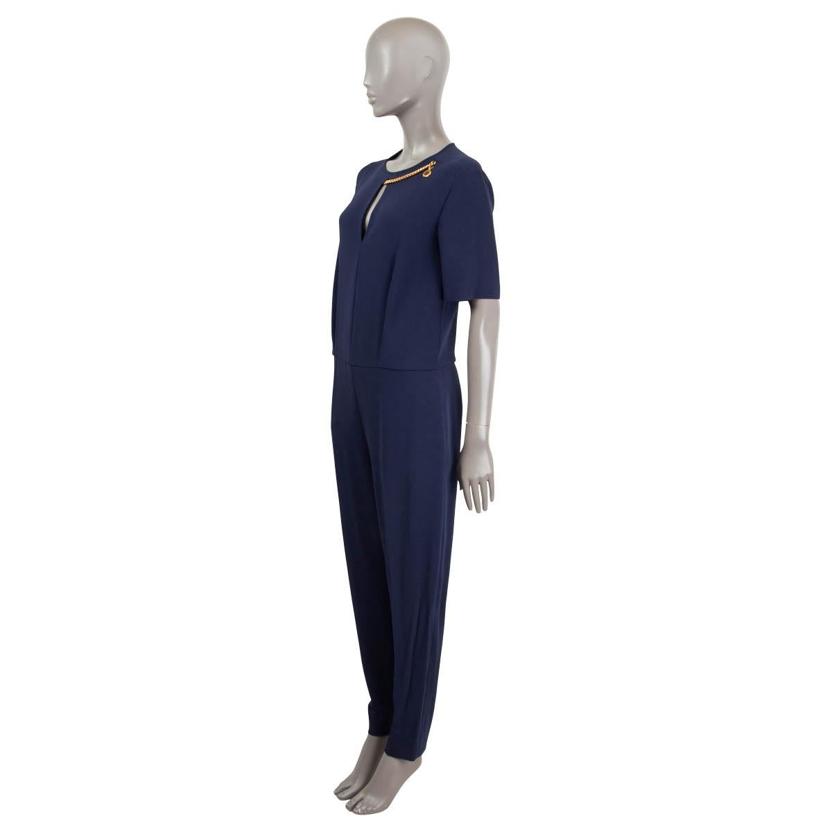 100% authentic Stella McCartney Jumpsuit in navy blue viscose (64%), acetate (32%) and elastane (4%).. Features a  round collar with a chain detail and wide-legs. Opens with a zipper on the back. Two sit pockets on the side. Has been worn and is in