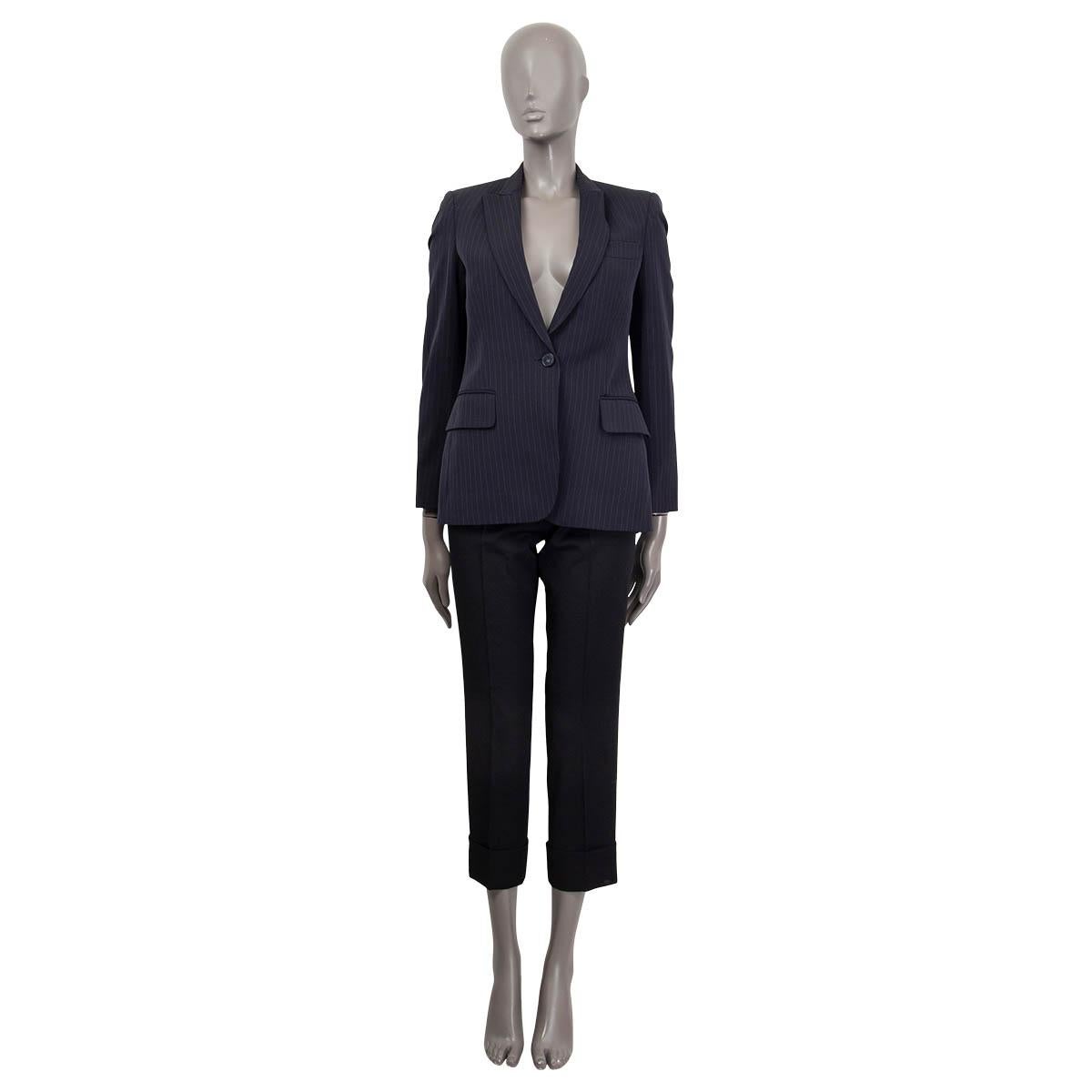 100% authentic Stella McCartney Peak Lapel Pin-Stripe Blazer in navy wool (99%) and polyester (1%). Lined in navy rayon (52%) and cotton (48%). Blazer closes with one button and features two flap pockets and one chest pocket at front. Has padded