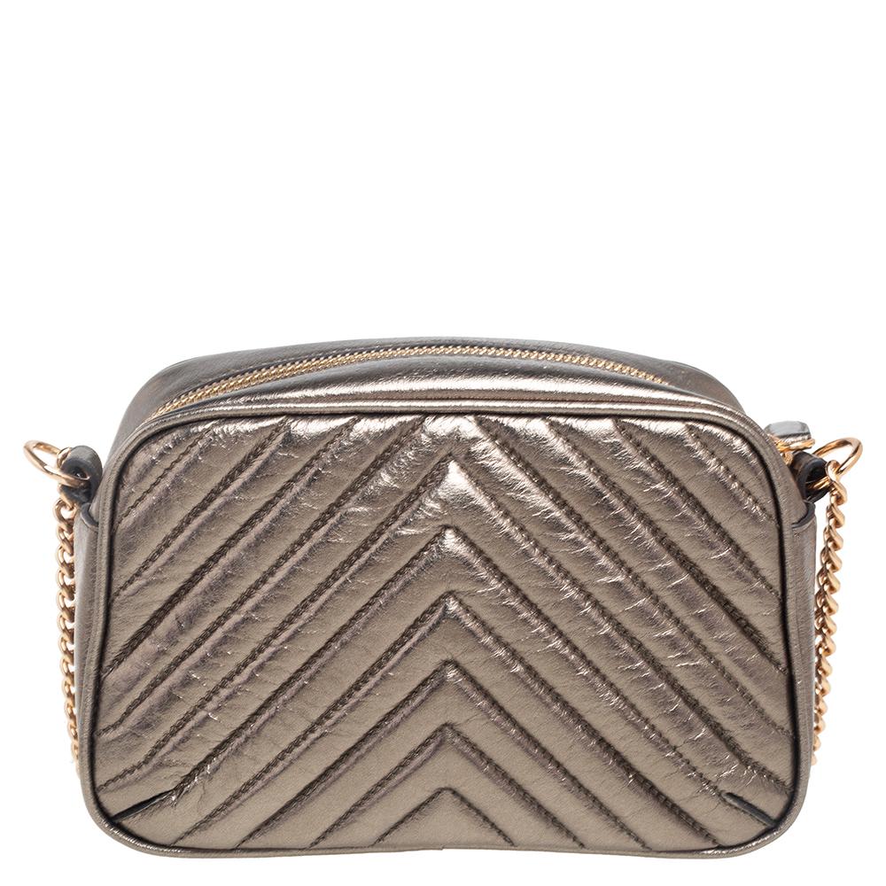 Coming from the House of Stella McCartney, this Stella Star crossbody bag will help your style sparkle! It is made from metallic olive green quilted faux leather and comes with a gold-toned star motif embellishment on the front. It has a faux