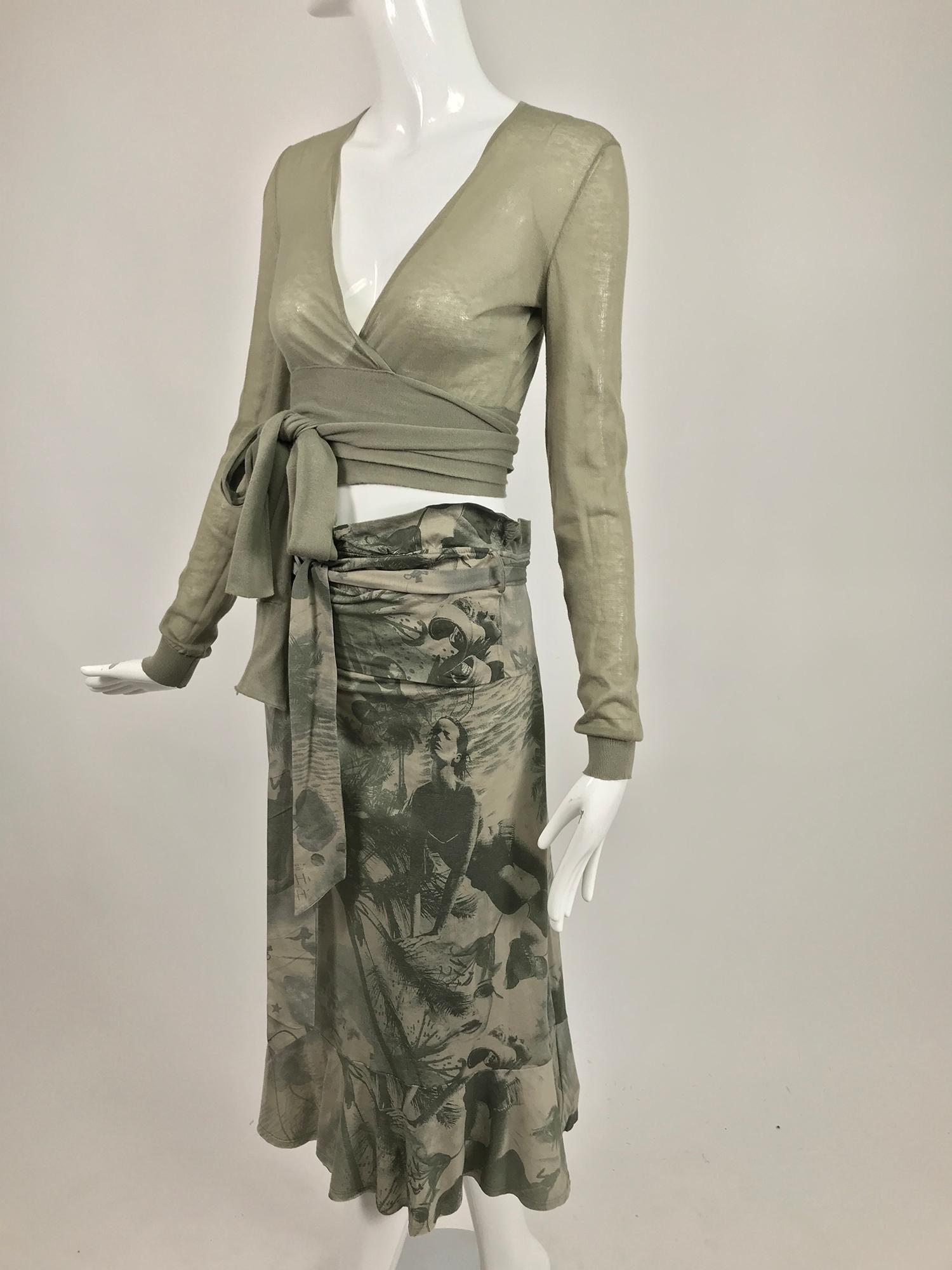 Stella McCartney photo print skirt and wrap sweater sweat set in a sage green and cream. The wrap waist sweater has long sleeves with fine rib cuffs, the fabric is a soft fine cotton knit. Long self ties at the waist wrap at the waist. V neckline.