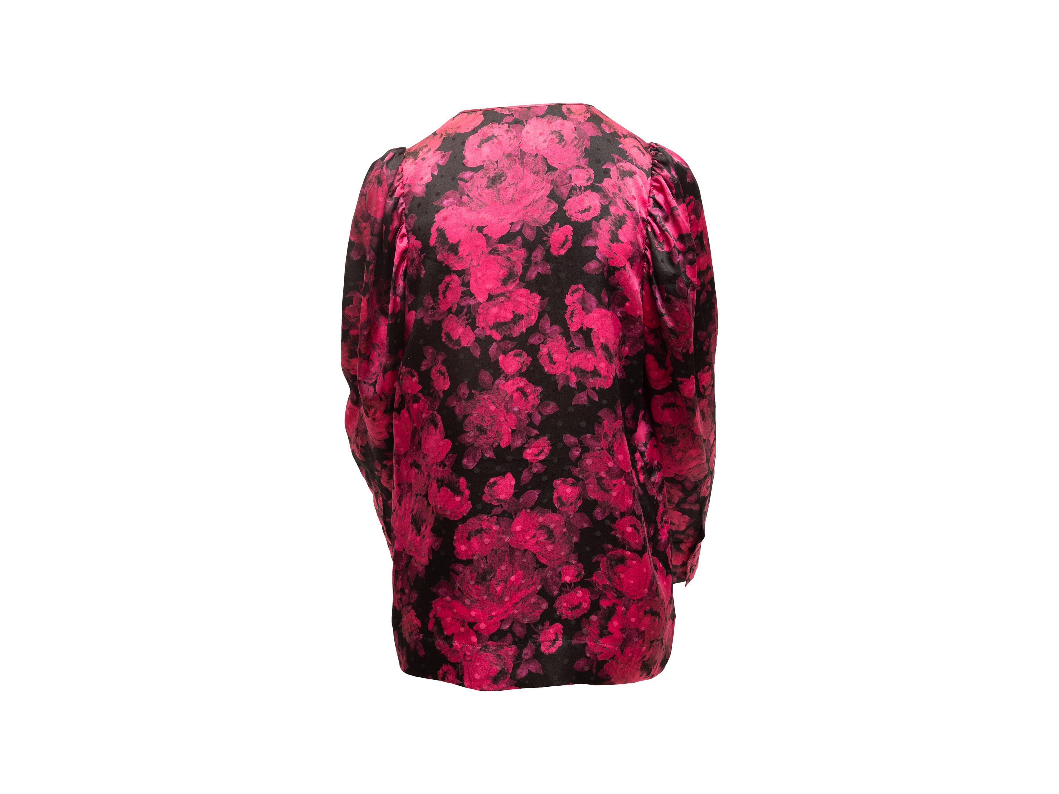 Product details: Pink and black silk long sleeve blouse by Stella McCartney. Floral print throughout. Crew neck. Button closures at front. Designer size 44. 36