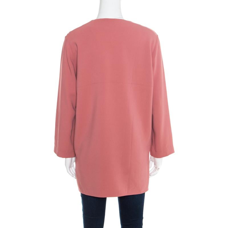 Include this Arlesa blouse from Stella McCartney in your closet to add color to your mundane formal wears. Crafted with pink crepe fabric, this lovely blouse comes with a zip detail on the front along with long sleeves and a relaxed silhouette. This