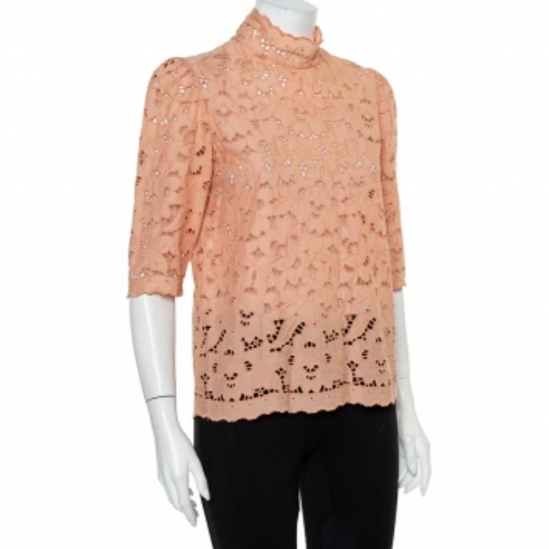This Stella McCartney top is an impeccable example of new-fashioned designs combined with subtle style. Skillfully tailored, this gorgeous top is crafted from eyelet lace in the shade of pink. Channel a chic, feminine vibe by styling it with a