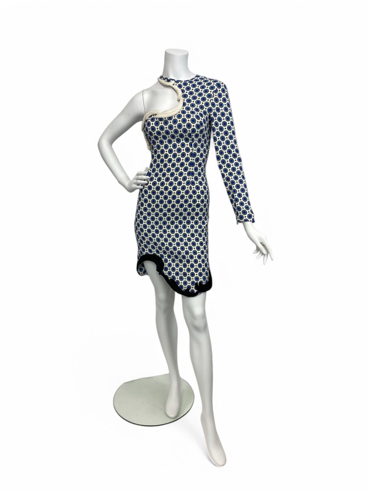 From Stella McCartney’s acclaimed Spring/Summer 2012 collection, this asymmetrical mini dress is a striking example of her signature sculptural tailoring and playful use of print. The dress features a dynamic mix of abstract patterns in a crisp