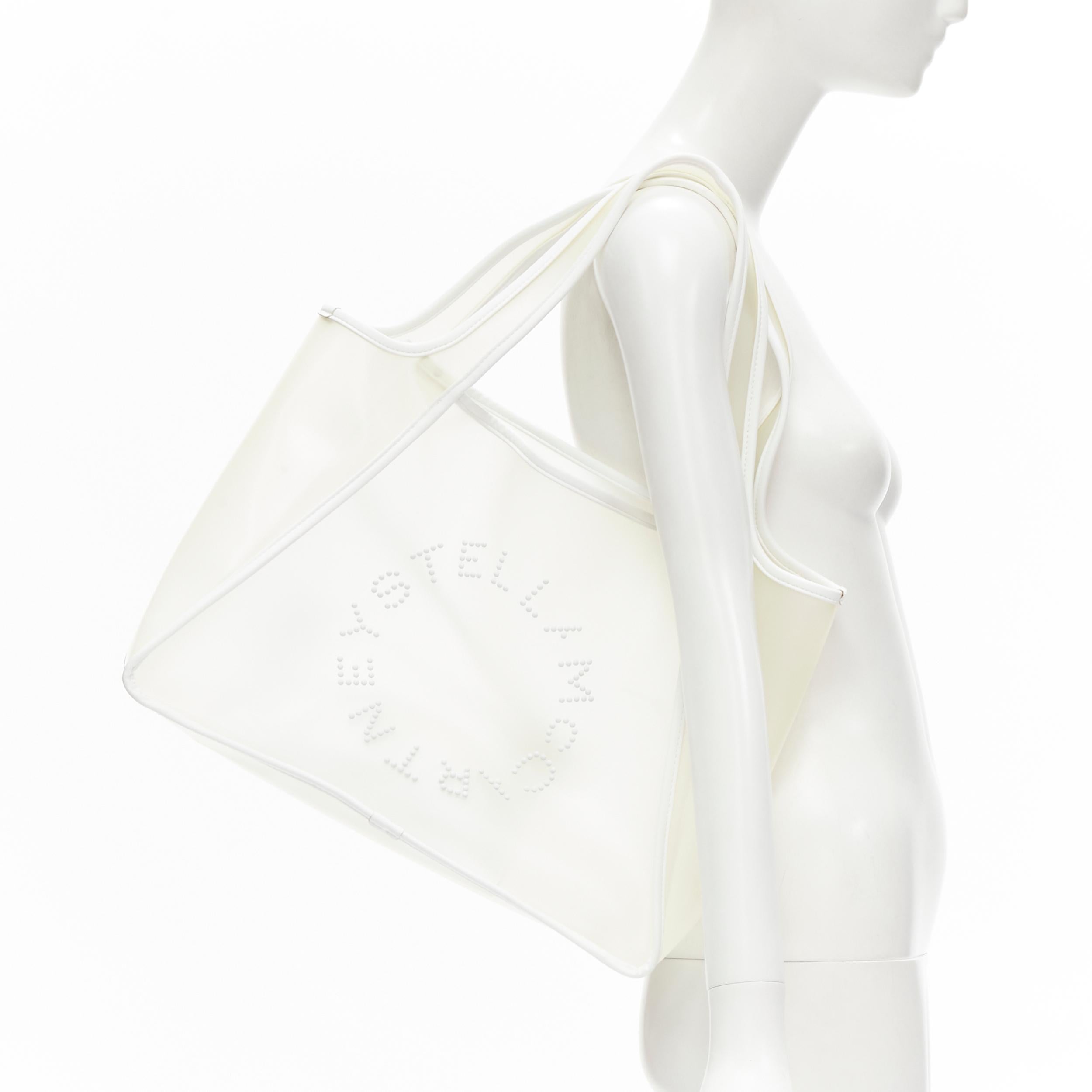 STELLA MCCARTNEY Signature Logo milk PVC white faux leather trim tote bag 
Reference: ANWU/A00005 
Brand: Stella McCartney 
Model: PVC tote 
Material: PVC 
Color: Clear 
Pattern: Solid 
Extra Detail: Comes with white faux leather envelope pouch at