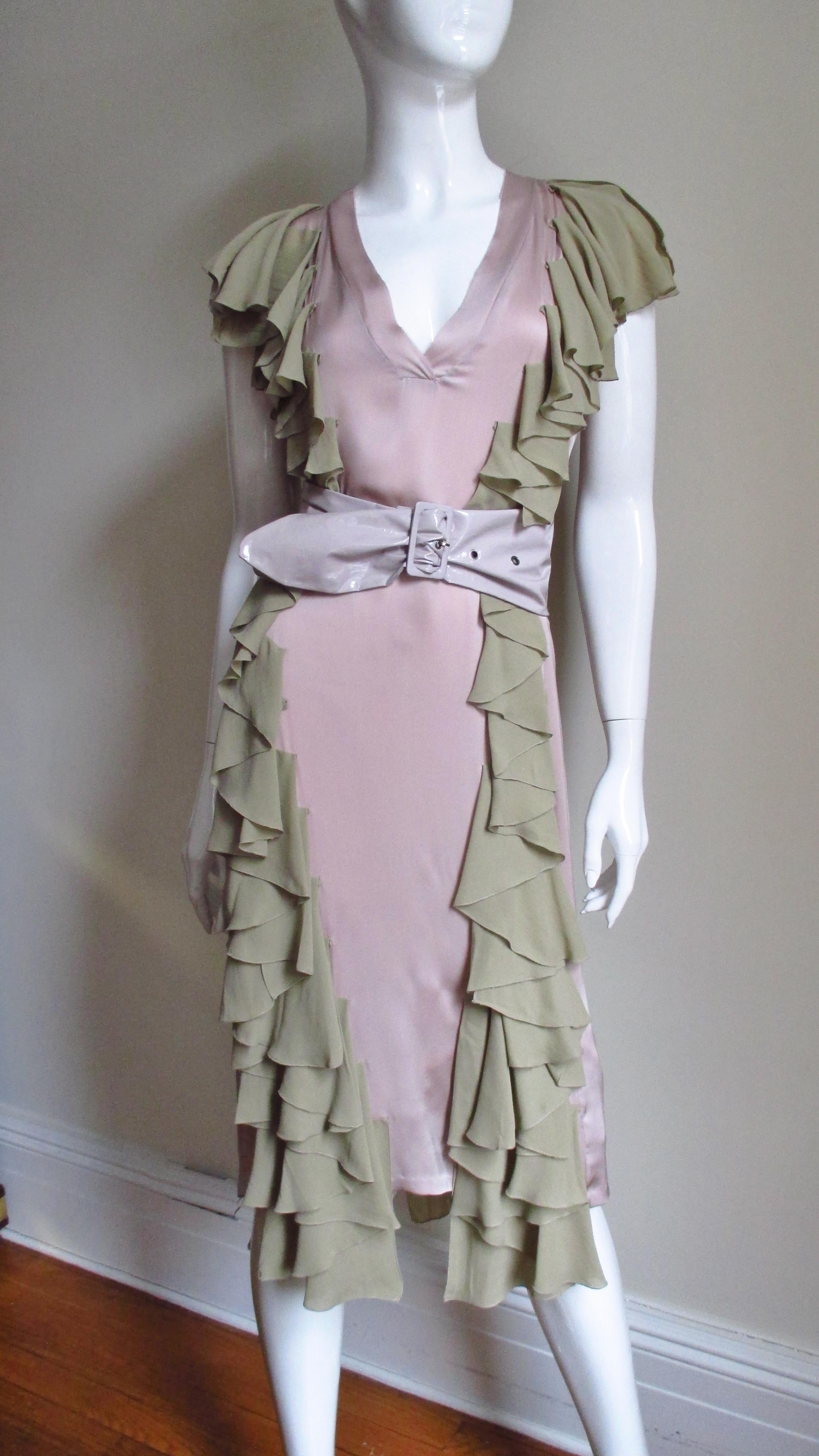A very pretty feminine dress in soft pink silk charmeuse with pale olive ruffles from Stella McCartney.  The color combination is beautiful.  It is a simple dress enhanced with ruffles down the entire length of the dress on each side of the front