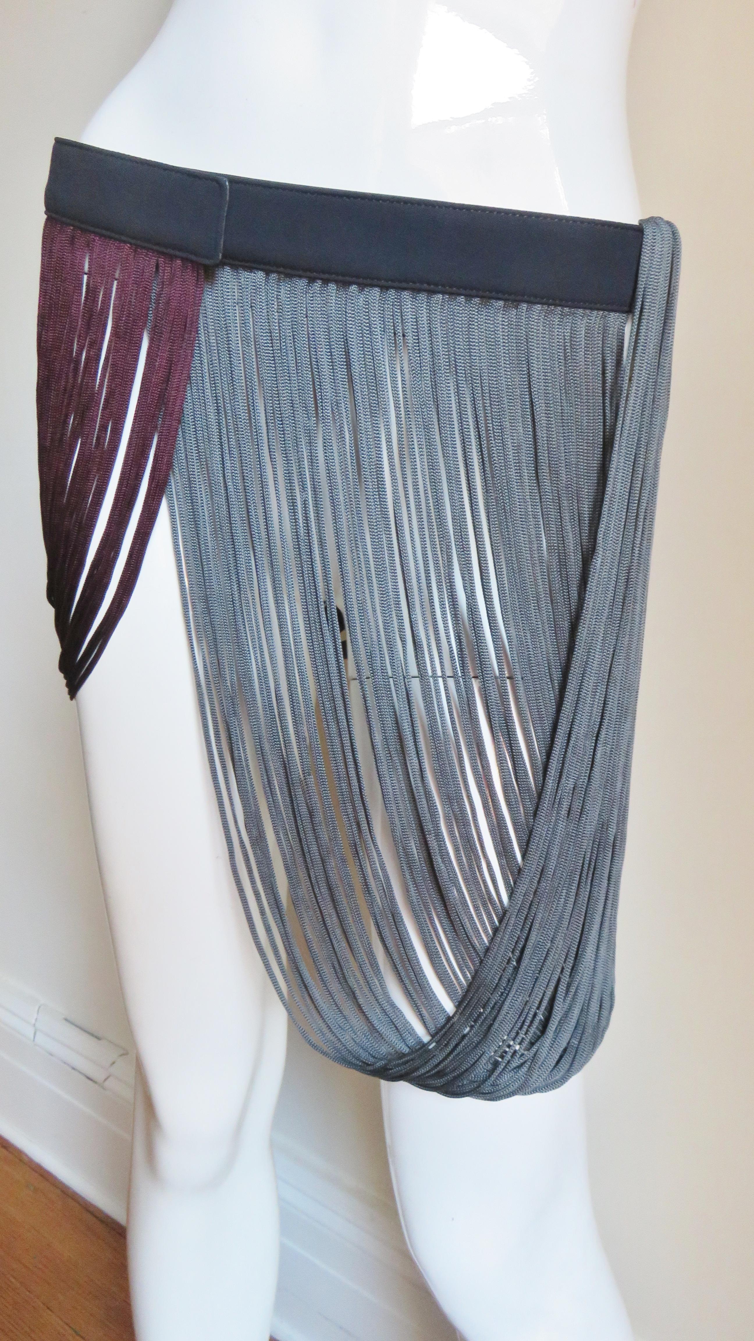 An incredible black silk belt from Stella McCartney with draping burgundy and grey silk fringe.  It snaps closed and is adjustable accommodating several sizes. New with box.
Fits sizes Small, Medium.

Width  1.50