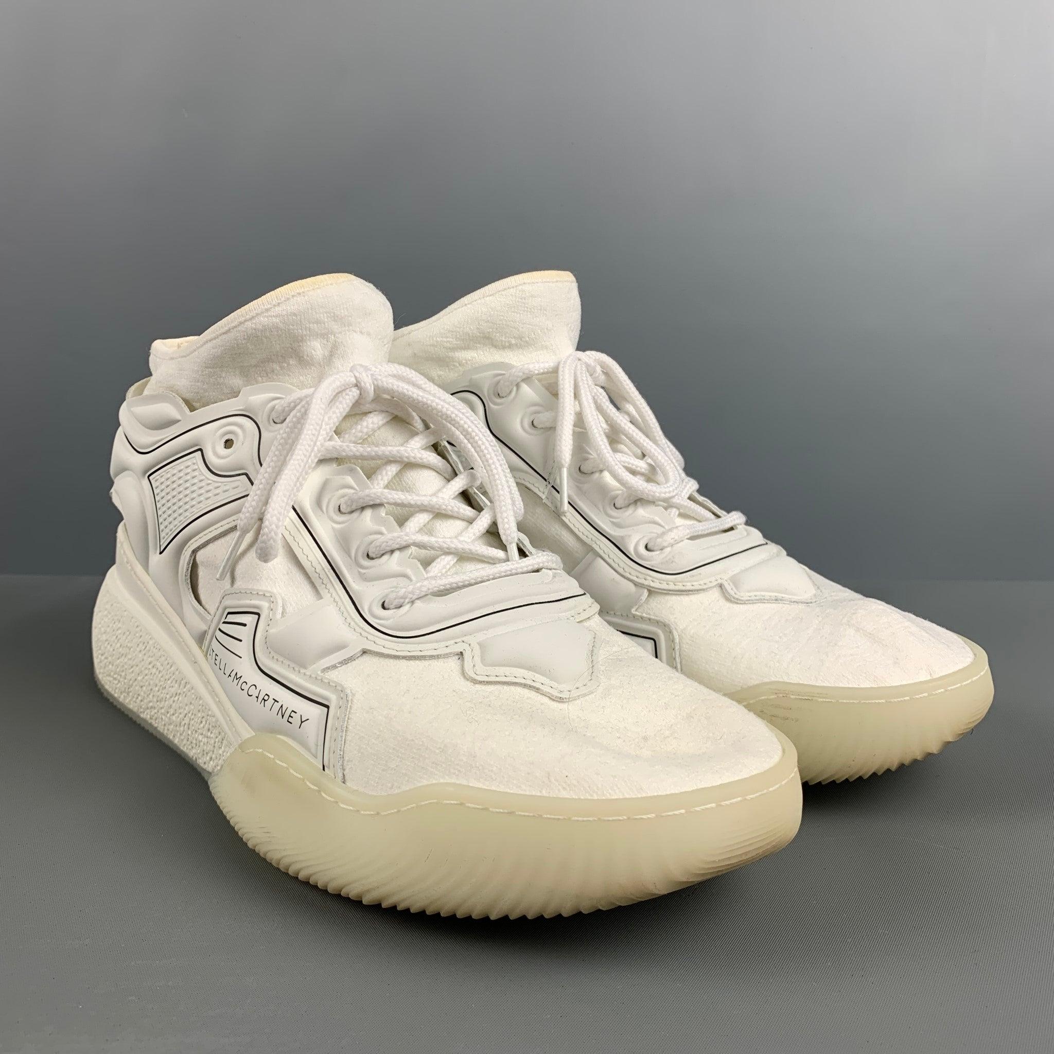 STELLA McCARTNEY ECLYPSE sneakers in a white knit material and rubber accents featuring a black contrast, high top style, chunky heel, and rubber sole. Made in Italy.Very Good Pre-Owned Condition. Minor signs of Wear. 

Marked:   44Outsole:13 inches