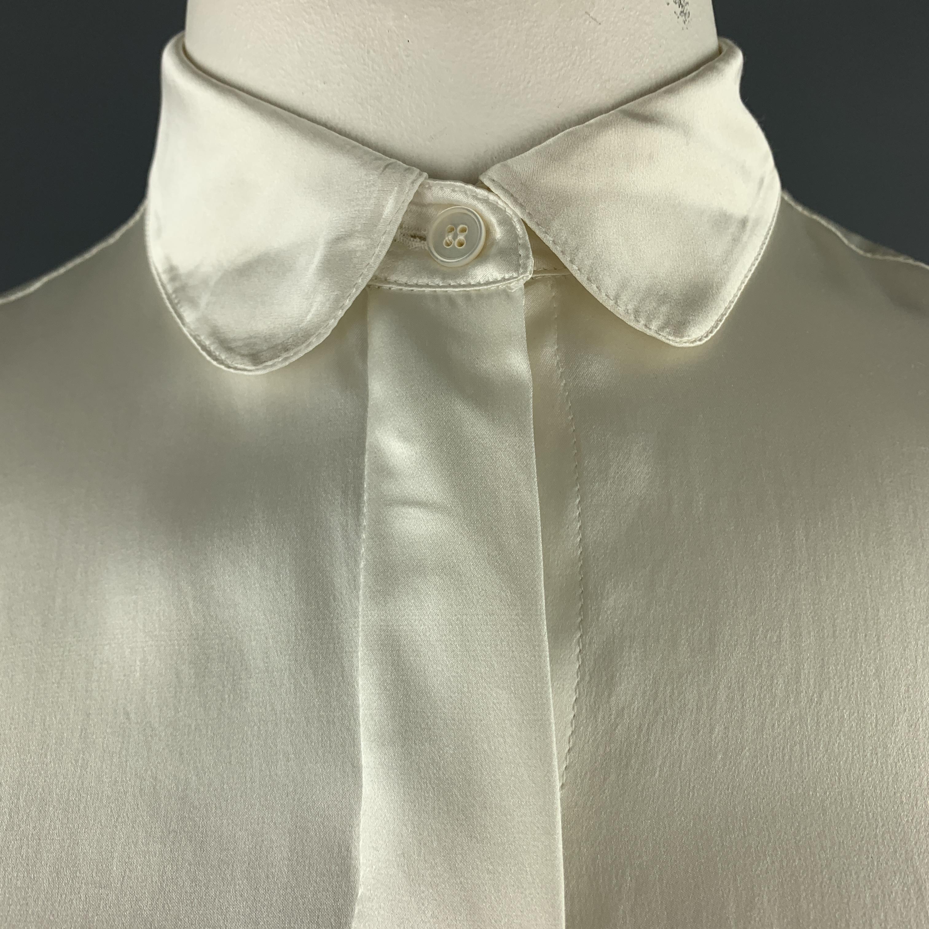 STELLA MCCARTNEY blouse comes in cream silk satin with a Peter Pan collar and hidden placket button front. 

Good Pre-Owned Condition.
Marked: IT 48
Original Retail Price: $600.00

Measurements:

Shoulder: 14 in.
Bust: 42 in.
Sleeve: 24 in.
Length: