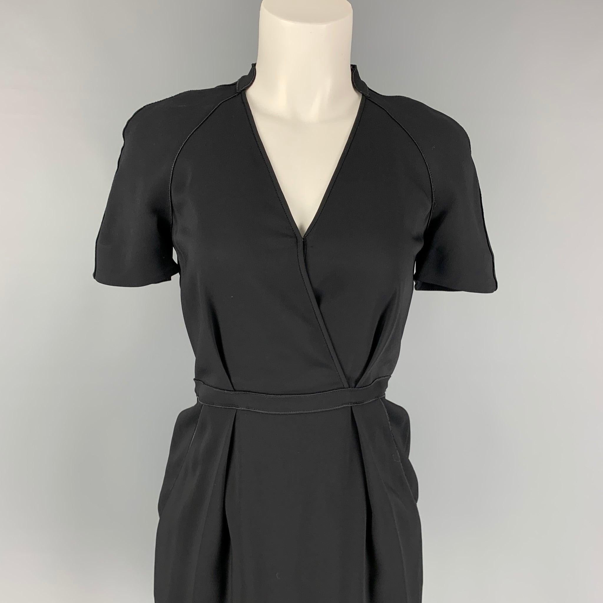STELLA McCARTNEY dress comes in a black viscose featuring a pleated style, a-line, slit pockets, short sleeves, and a back zipper closure.
Very Good
Pre-Owned Condition. 

Marked:   38 

Measurements: 
 
Shoulder: 16.5 inches  Bust: 30 inches 