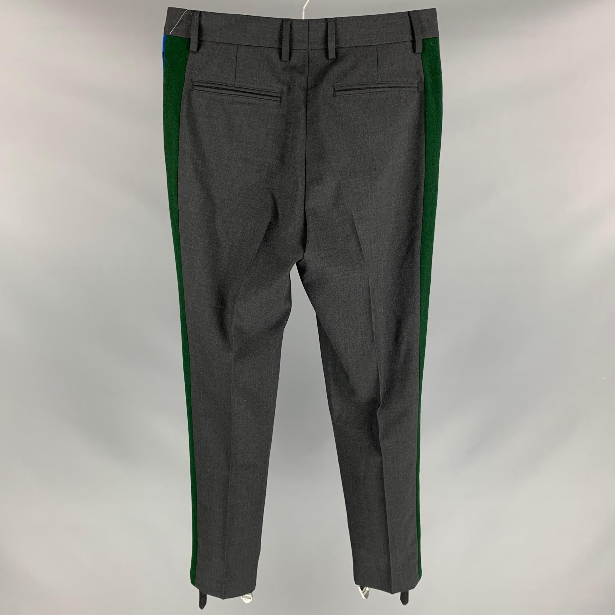 STELLA McCARTNEY tuxedo dress pants comes in a charcoal wool with a green & blue side stripe featuring a stirrup buckle closure detail, slim fit, and a zip fly closure. Made in Italy. 
 
Excellent Pre-Owned Condition.
Marked: