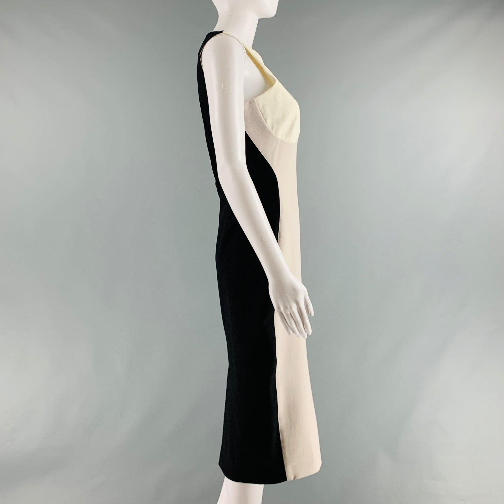 STELLA McCARTNEY 2011 midi dress comes in a black, beige and off white polyamide and elastane knit material featuring a contrast panels, back slit, body con style, and a back zip up closure. Excellent Pre-Owned Condition. 

Marked:   6