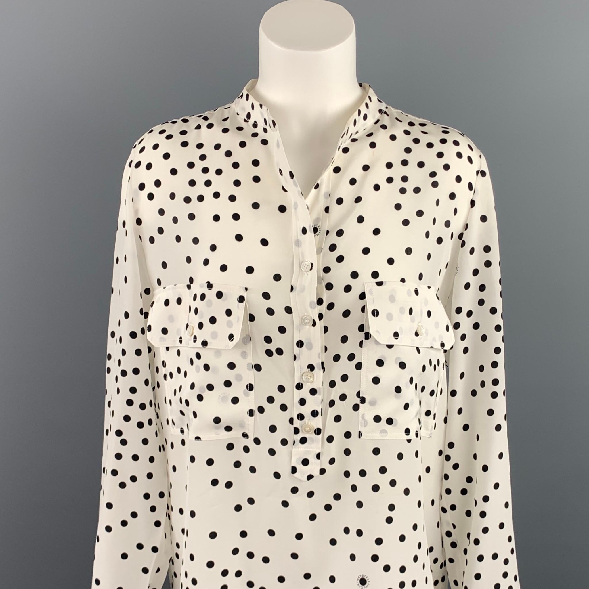 STELLA McCARTNEY blouse comes in a black & white dot print silk featuring pockets, collarless, and a half buttoned closure.

Very Good Pre-Owned Condition.
Marked: 42    
Original Retail Price: $960.00

Measurements:

Shoulder: 15 in. 
Bust: 42 in.