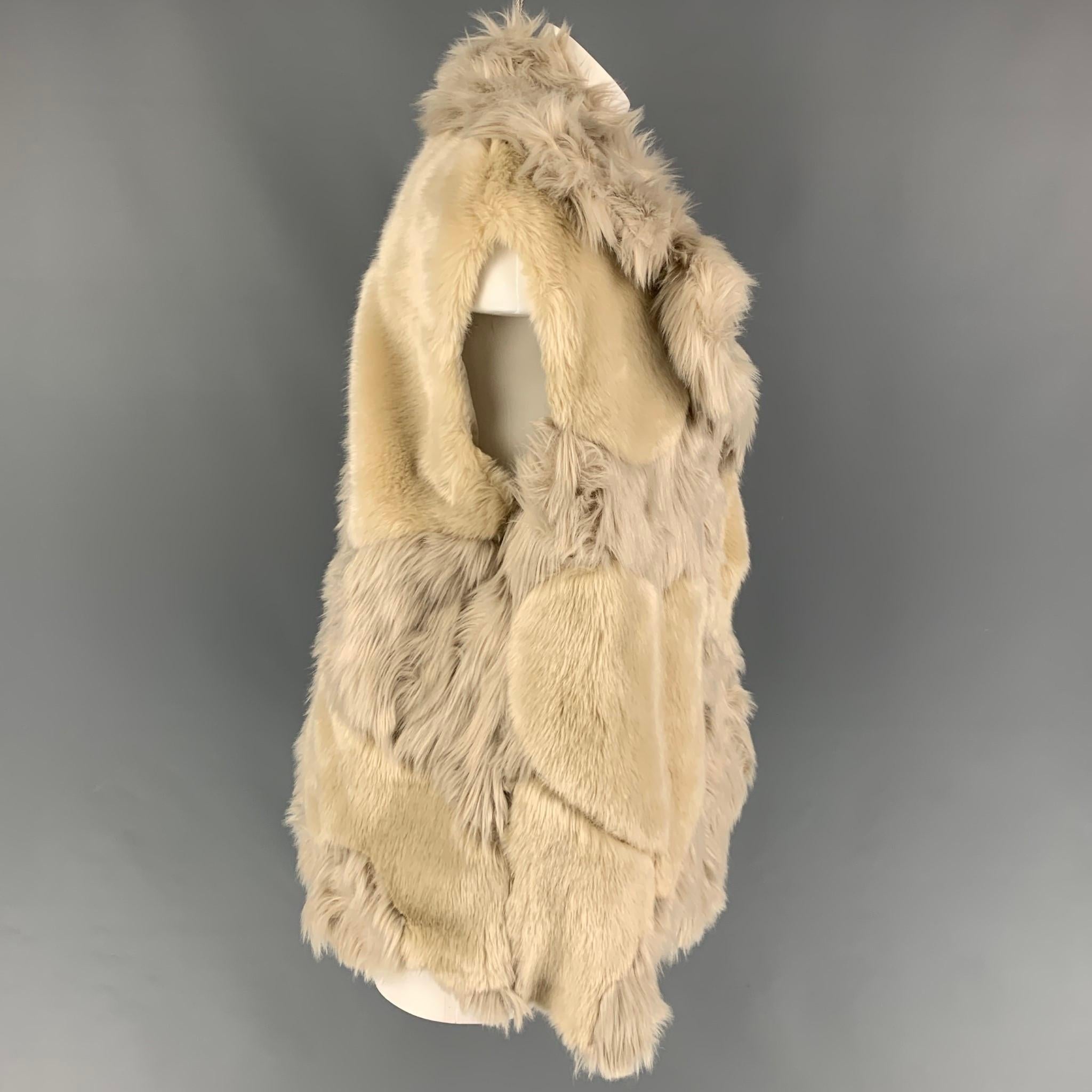 STELLA McCARTNEY 'Fur Free Fur' vest comes in a tan acrylic faux fur with a full liner featuring a large lapel design, slit pockets, and a hook & loop closure. Made in Hungary. 

Very Good Pre-Owned Condition.
Marked: 38
Original Retail Price: