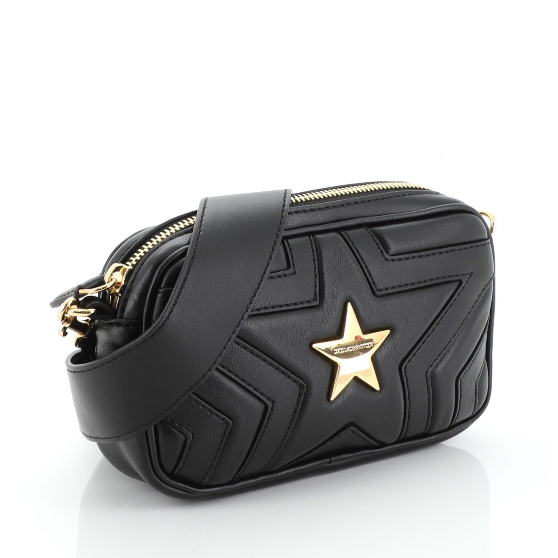 This Stella McCartney Stella Star Convertible Waist Bag Quilted Faux Leather, crafted from black quilted faux leather, features adjustable waist strap, laser cut quilted star design and gold-tone hardware. Its zip closure opens to a gray microfiber