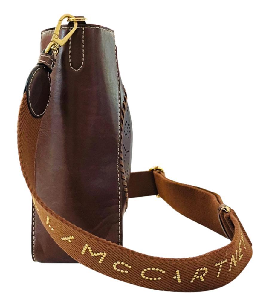 Stella McCartney Vegan Leather Logo Shoulder Bag
Cognac brown rectangle-shaped bag crafted in smooth alter mat vegan leather.
Detailed with perforated 'Stella McCartney' logo in tonal topstitching circle.
Featuring logo printed, detachable canvas