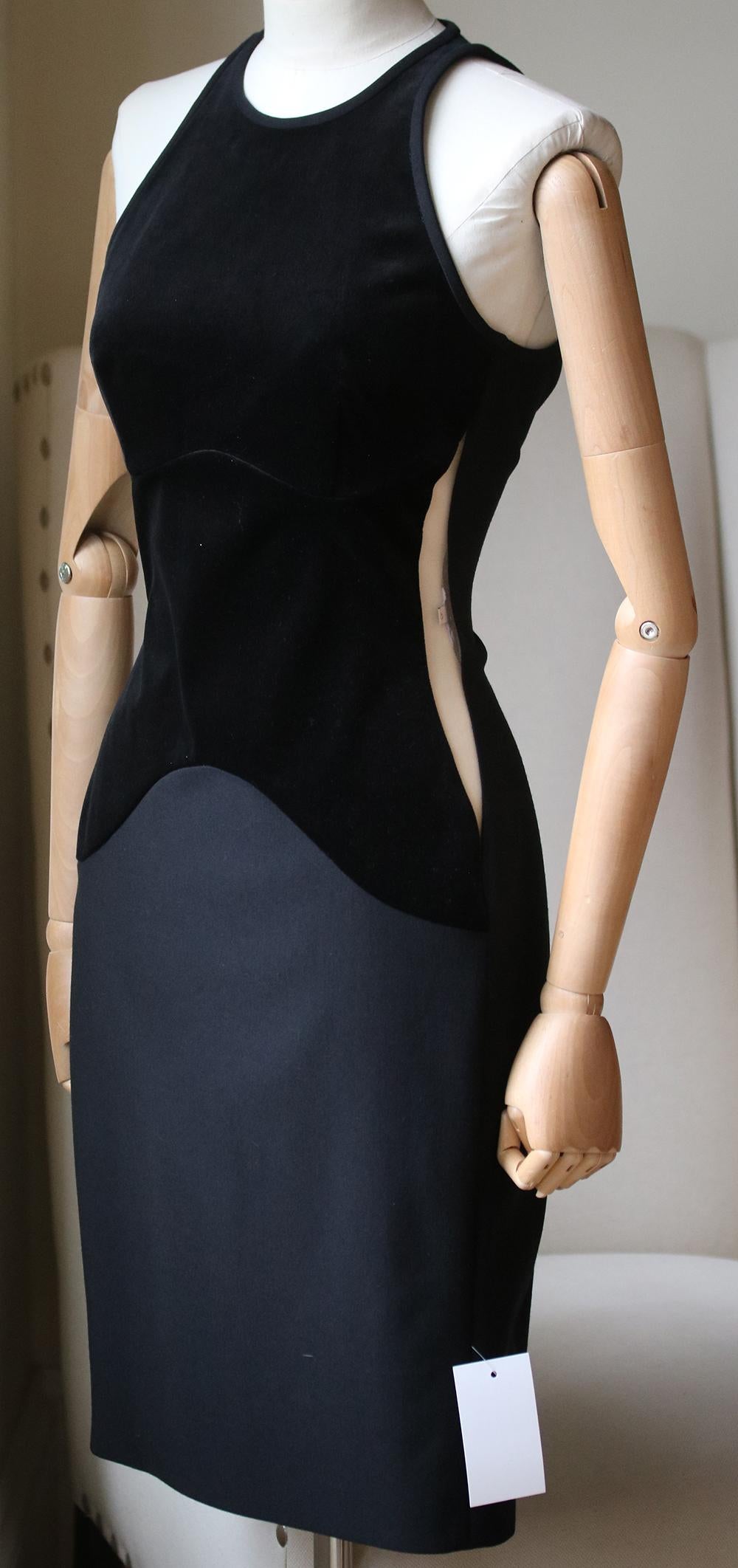 This iconic black sleeveless dress from Stella McCartney has a round neck, nude sheer mesh cut-out panels at the sides, velvet panelling and centre-back fastening. 

Size: IT 42 (UK 10, US 6, FR 38)

Condition: As new condition, no sign of wear. 