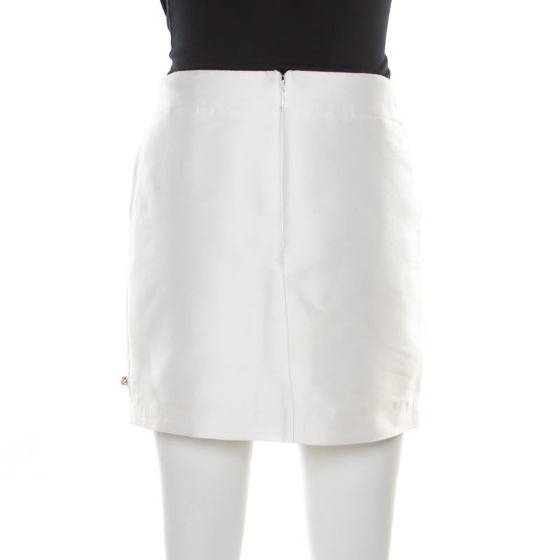 This stylish mini skirt from Stella McCartney is an extremely unique piece. The designer skirt has detailed stone and beads embellishments depicting different accessories from a woman's wardrobe. It also has a zip closure at the back for a perfect