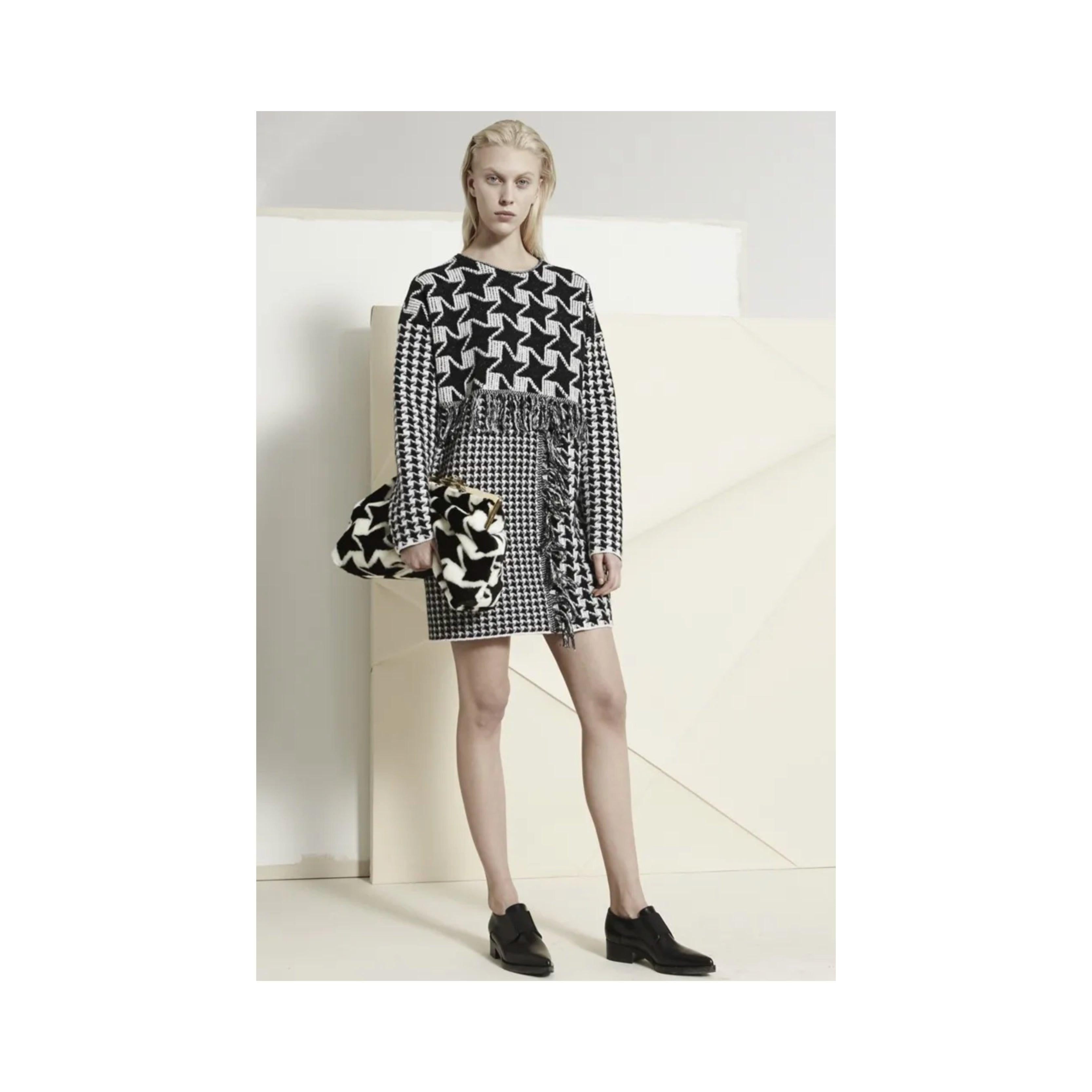 Elevate your winter wardrobe with the Stella McCartney Wool Dress from the Pre Fall 2014 collection. Crafted from 100% virgin wool, this oversized shift dress features a mix of Houndstooth pattern in a monochrome color palette. 
 Material: 100%