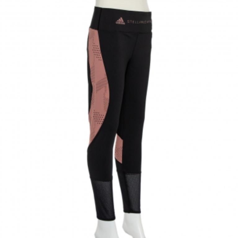 Exhibiting chic aesthetics, these black and pink perforated knit leggings from Stella McCartney x Adidas are visually appealing and highly comfortable. They have been designed with logo details on the waistband and sheer panels towards the bottom.
