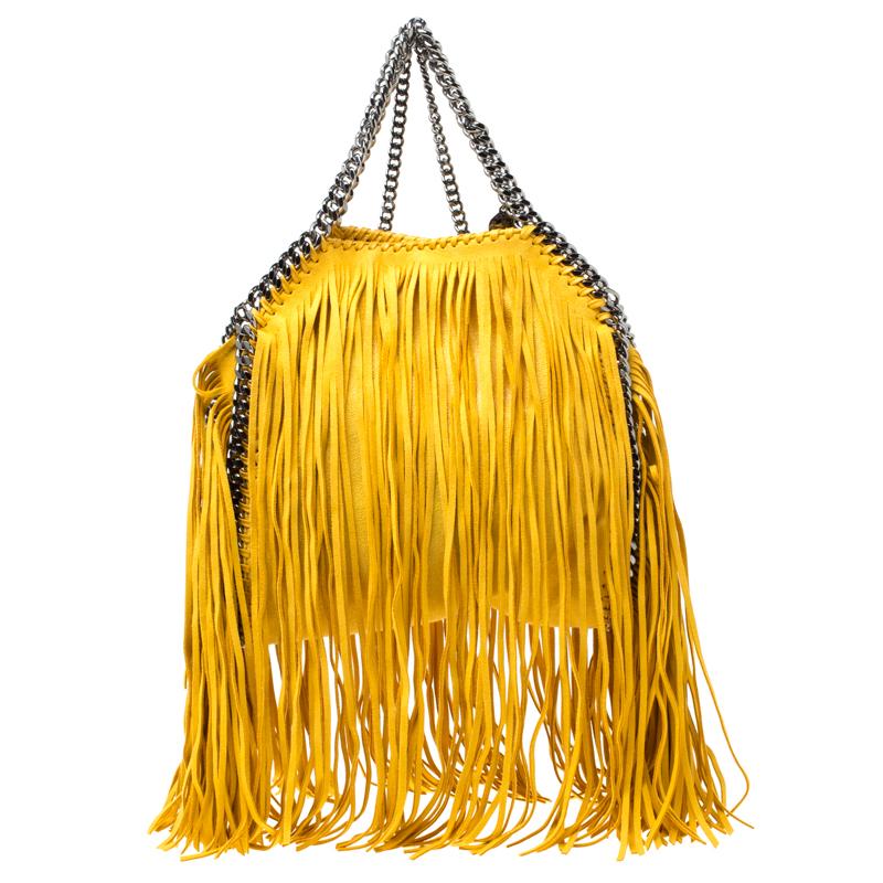 Stella McCartney is known for her chic designs and this mini Falabella fringe tote perfectly embodies this trait. Crafted in Italy from yellow faux leather with a fabric interior, this bag has a beautiful allover fringe exterior and black-tone chain
