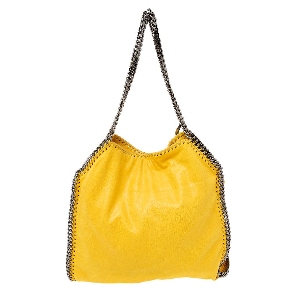 This yellow Falabella bag from Stella McCartney is a beauty. Crafted from faux suede, it is durable and stylish. While the chain detailing elevates its beauty, the lined interior will dutifully hold all your daily essentials.

Includes: Original