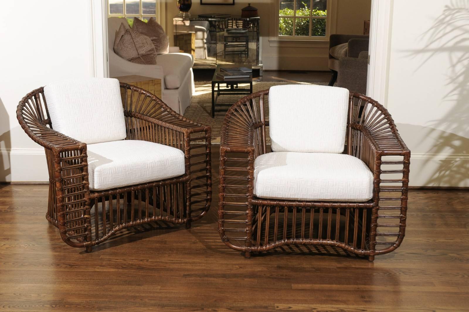An exquisite restored pair of vintage rattan and cane lounge or club chairs. These unusual chairs are consistent with the rare Tiara series by the Esteemed Henry Olko for his Willow and Reed firm, circa 1979. These particular pieces are not marked.