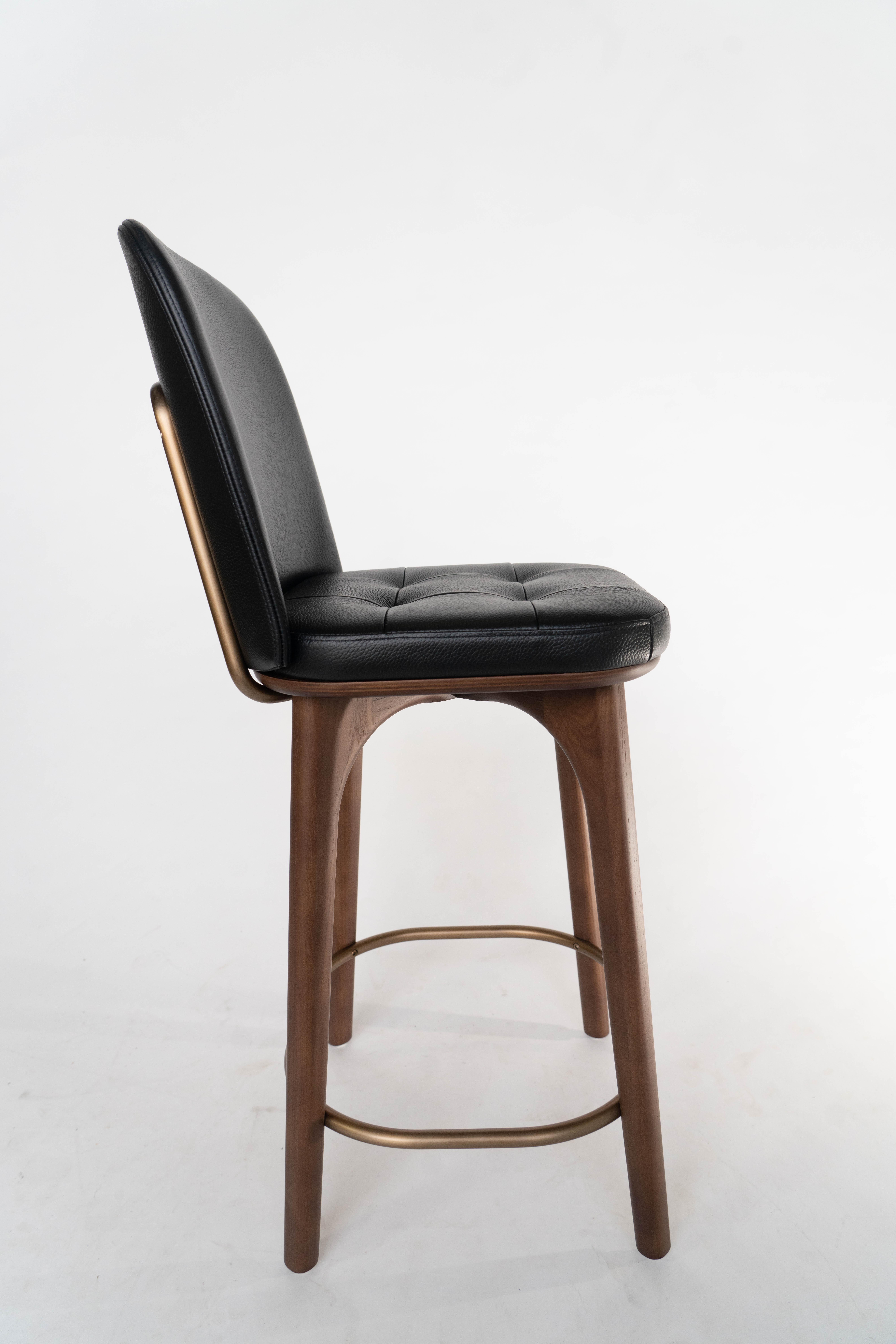 This solid wood and grained leather bar chair is built to last and is often used in hospitality projects but would fit just as well in someones home.  It is in an Ash wood, which happens to no longer be in use for us but is brand new in the