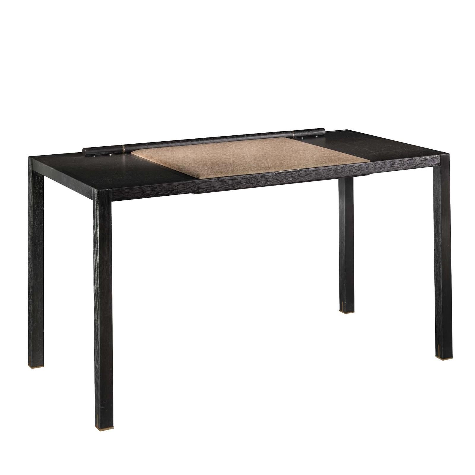 Inspired by 1950s Italian design, this sleek desk will add a stylish flair to any space with its matte black stained oak frame raised on four straight legs. The desktop features a flip blotter made of tanned leather (also available in stained cork),