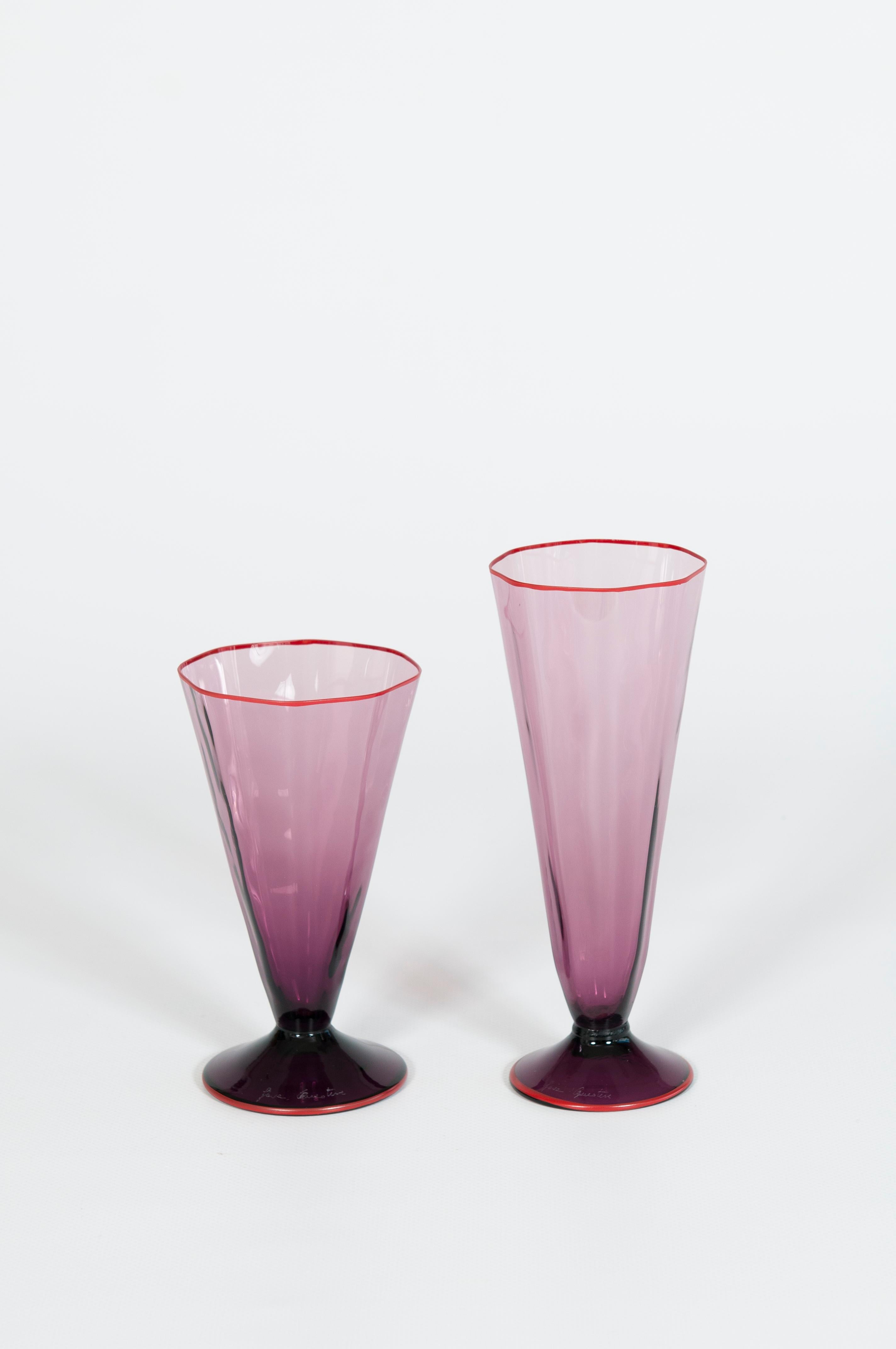 Stem Glasses' Pair in Amethyst Blown Murano Glass and Coral Borders Italy 1960s
The production of this unique pair of stem glasses dates back to the 1960s in Murano, the Venetian island famous for its unrivaled blown glass tradition. Entirely