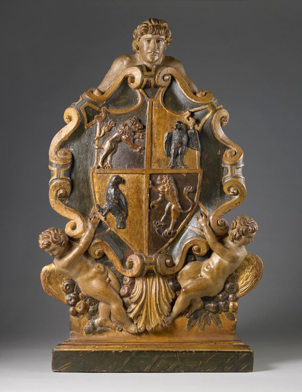 Artiste actif en Italie du Nord, XVIIe siècle 

Armoiries héraldiques : Écu écartelé au premier et au quatrième en noir avec un lion rampant,
 aux deuxième et troisième aigles d'or


Noyer sculpté, polychrome et doré, 88 x 55,5 x 4,5 cm


Armoiries