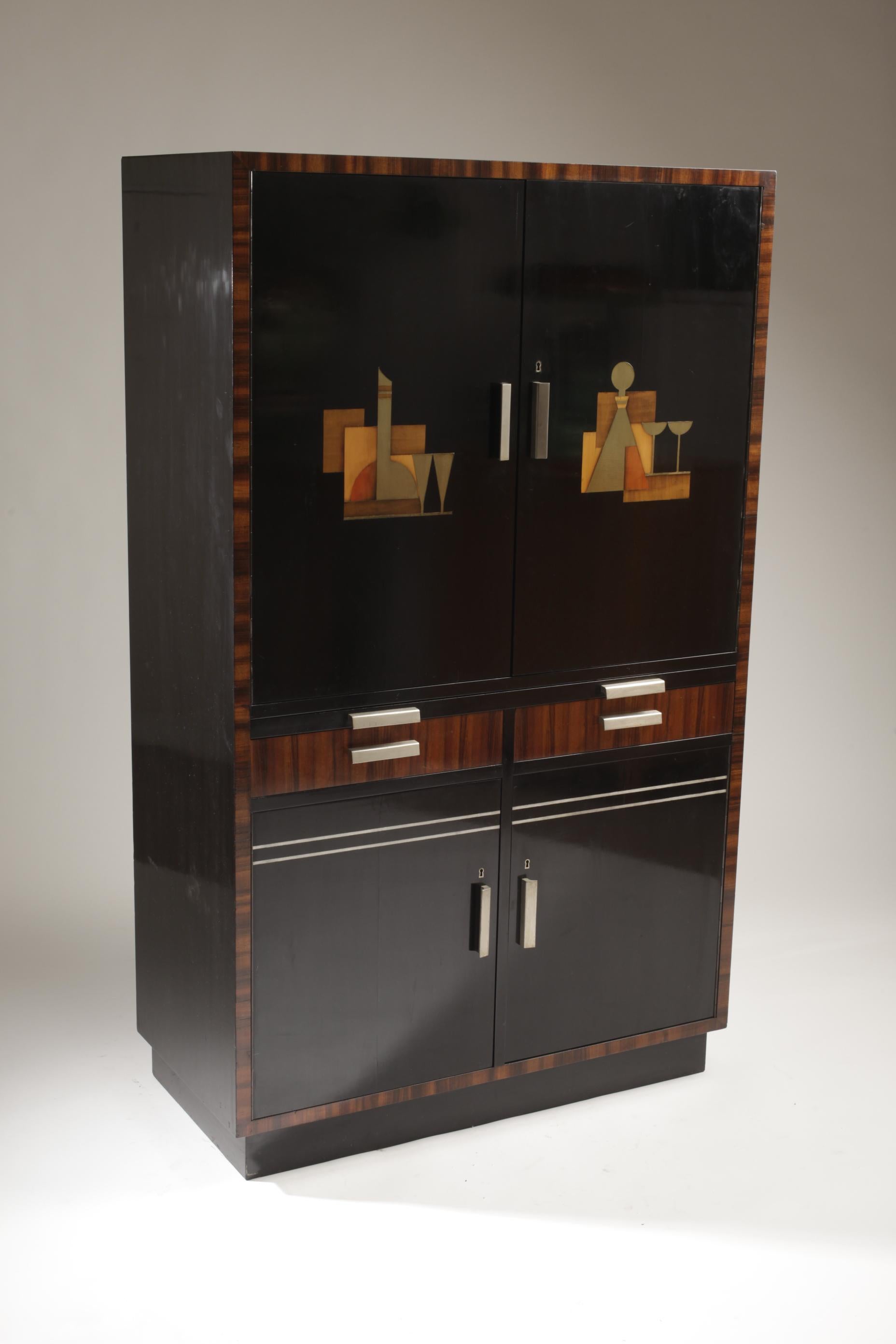 A rare bar cabinet designed by Sten Blomberg for Firma David Blomberg, Swedish Art Deco / 1930s. Inlays of metal and wood. 

Beautiful red colored interiors of the cabinet. Bottle holders and drawers, handles in wood and brushed steel. 

With