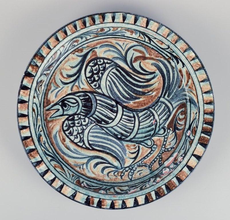 Sten Lindgren, Swedish ceramist for Porches Algarve. 
Colossal unique ceramic bowl with a bird motif.
Polychrome glaze.
In excellent condition.
Signed and dated 1980 on the back.
Dimensions: Diameter 39.0 cm x Height 4.5 cm.




