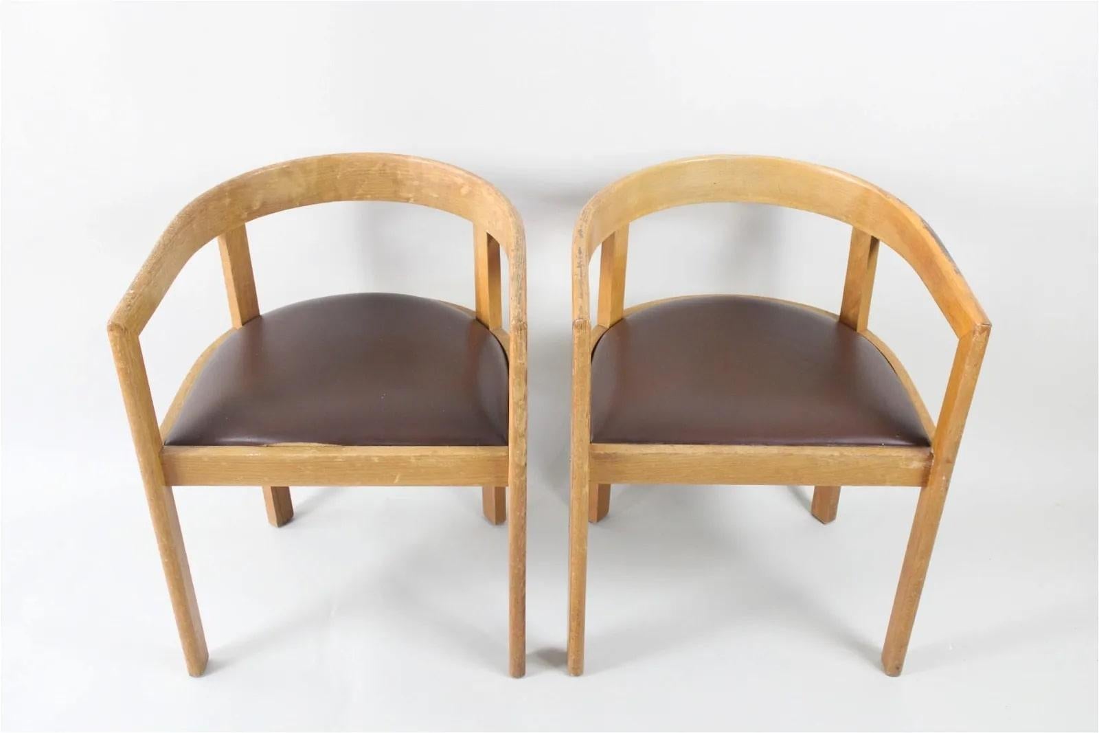 Great matching pair are club-chair shape, with smooth, rounded back and arm rests, with brown leather seats.

Condition is good with one chair repaired, surface wear and scuffs commensurate with age.  Leather needs slight refinishing on one (see